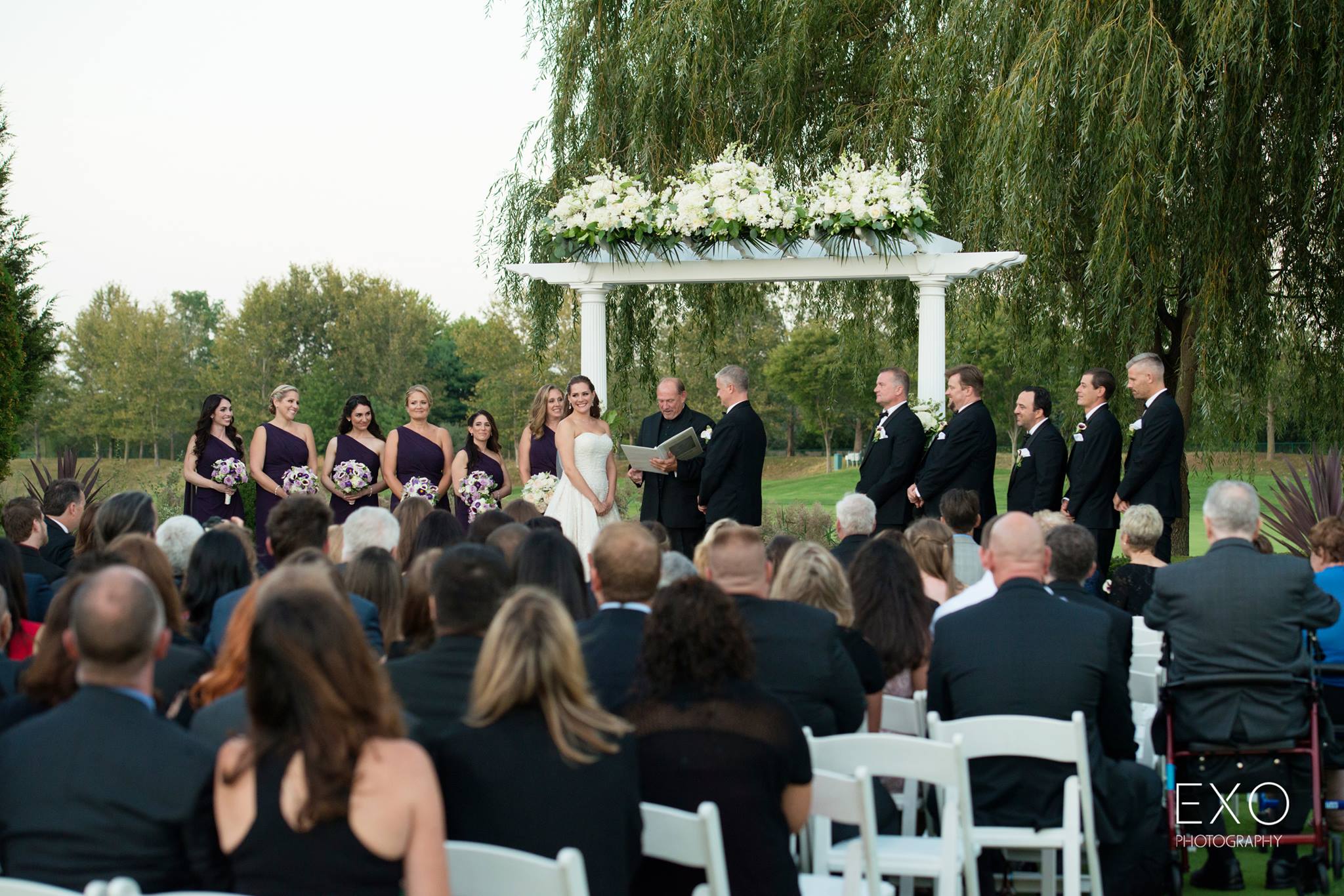 bride and groom at altar of outdoor Willow Creek Golf and Country Club wedding
