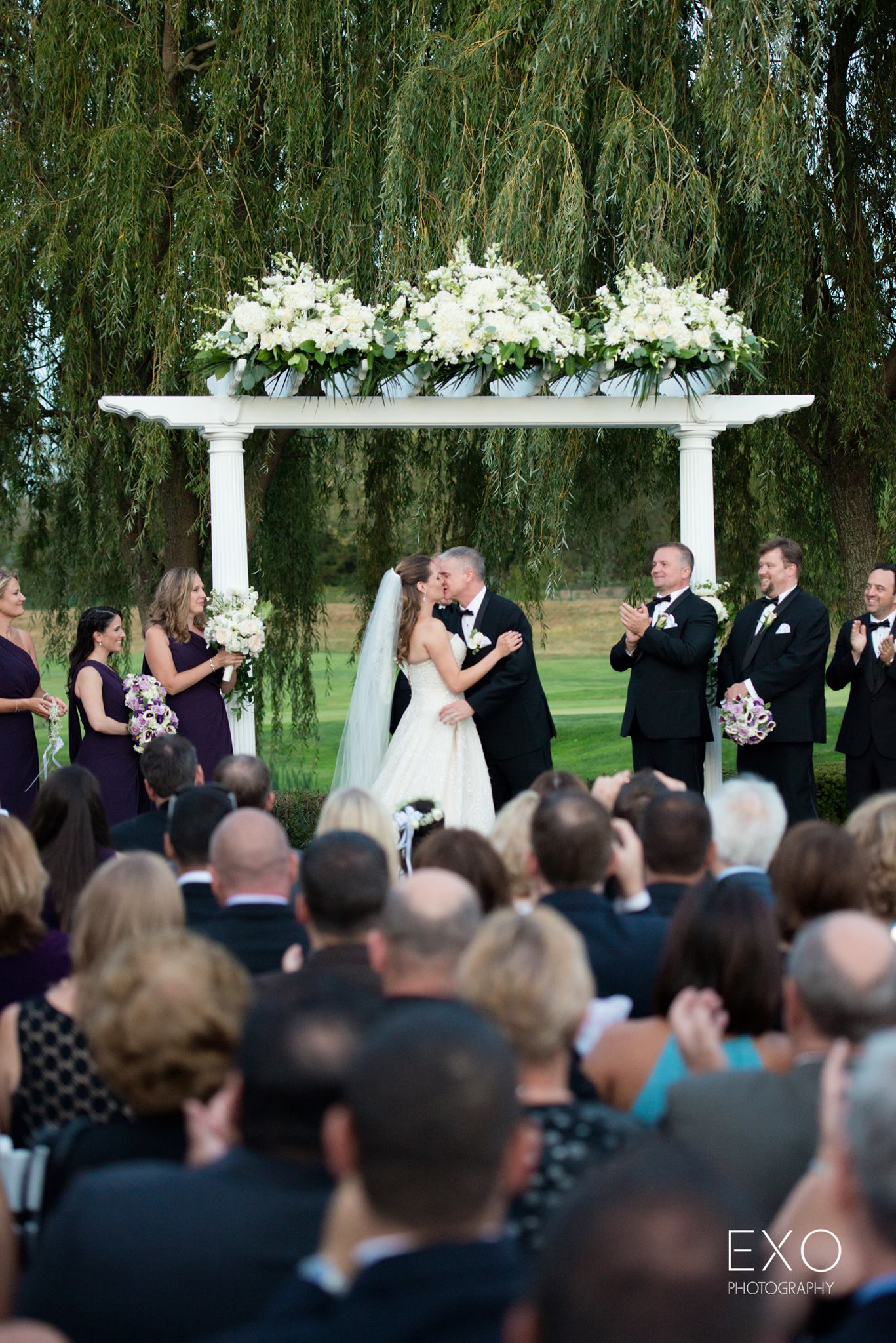 bride and groom kissing at Willow Creek Golf and Country Club wedding ceremony