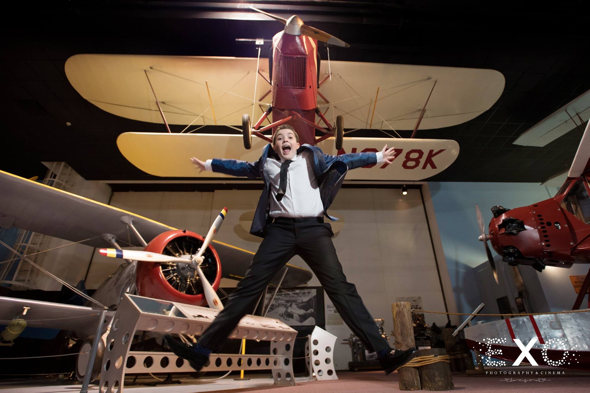 bar mitzvah boy jumping in front of plane