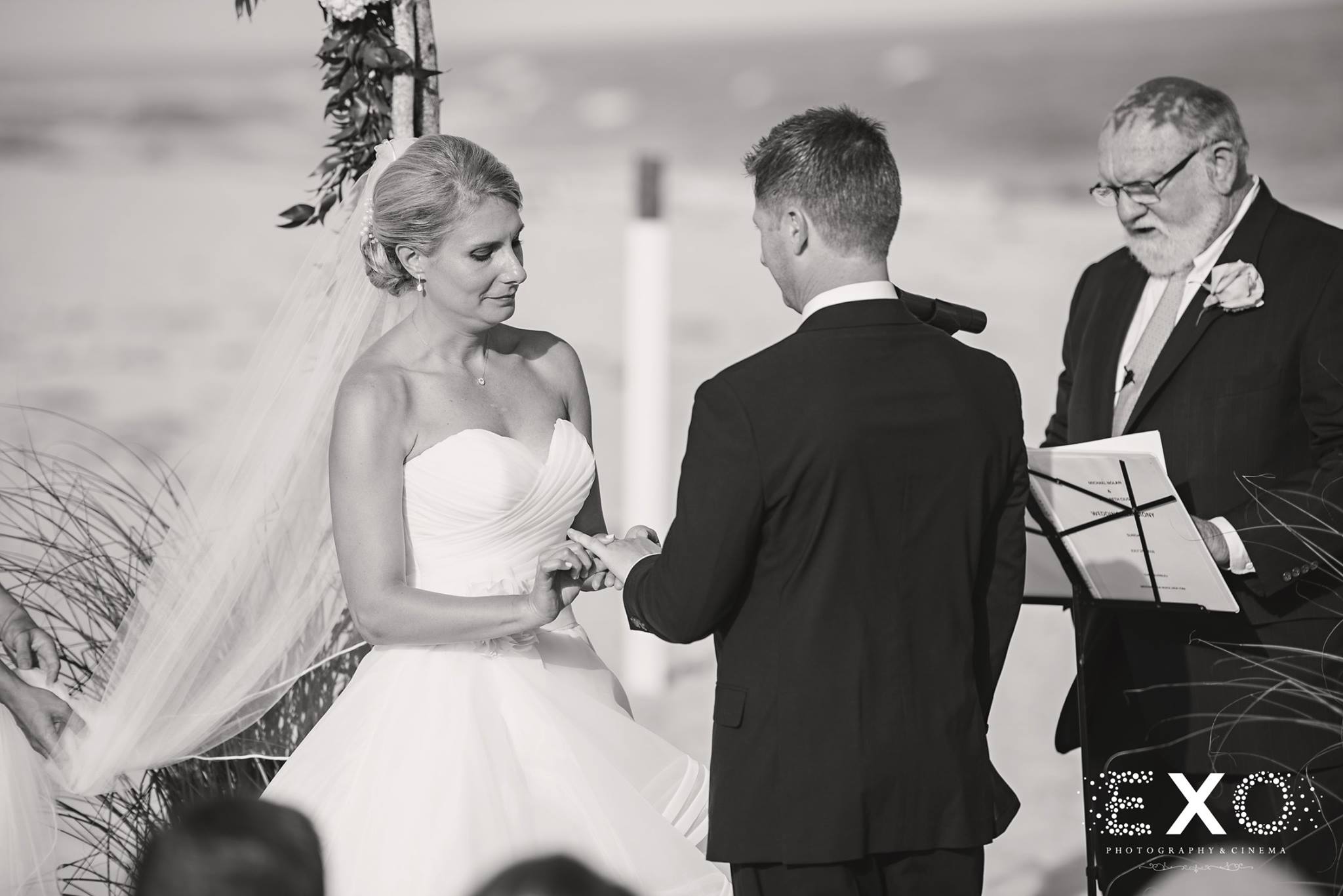 black and white image of bride and groom at altar 