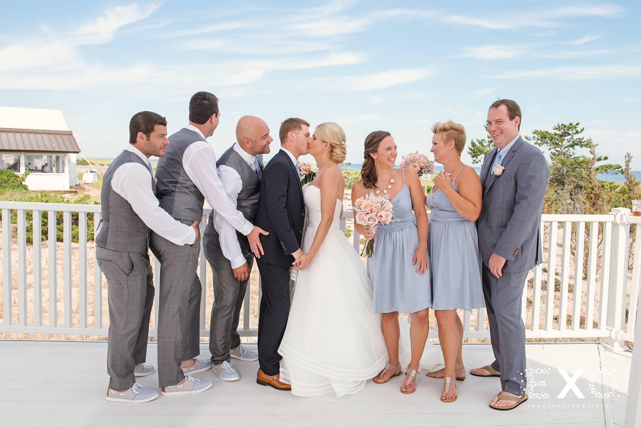 bride, groom, and wedding party standing together