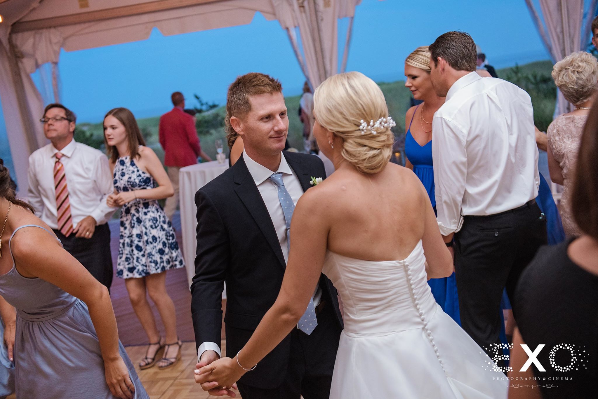 bride and groom dancing together at reception at Oceanbleu