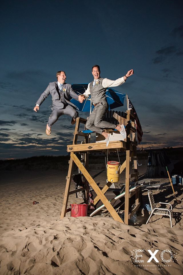Groom and groomsmen jumping from stand wearing express suit and brooks brothers suit