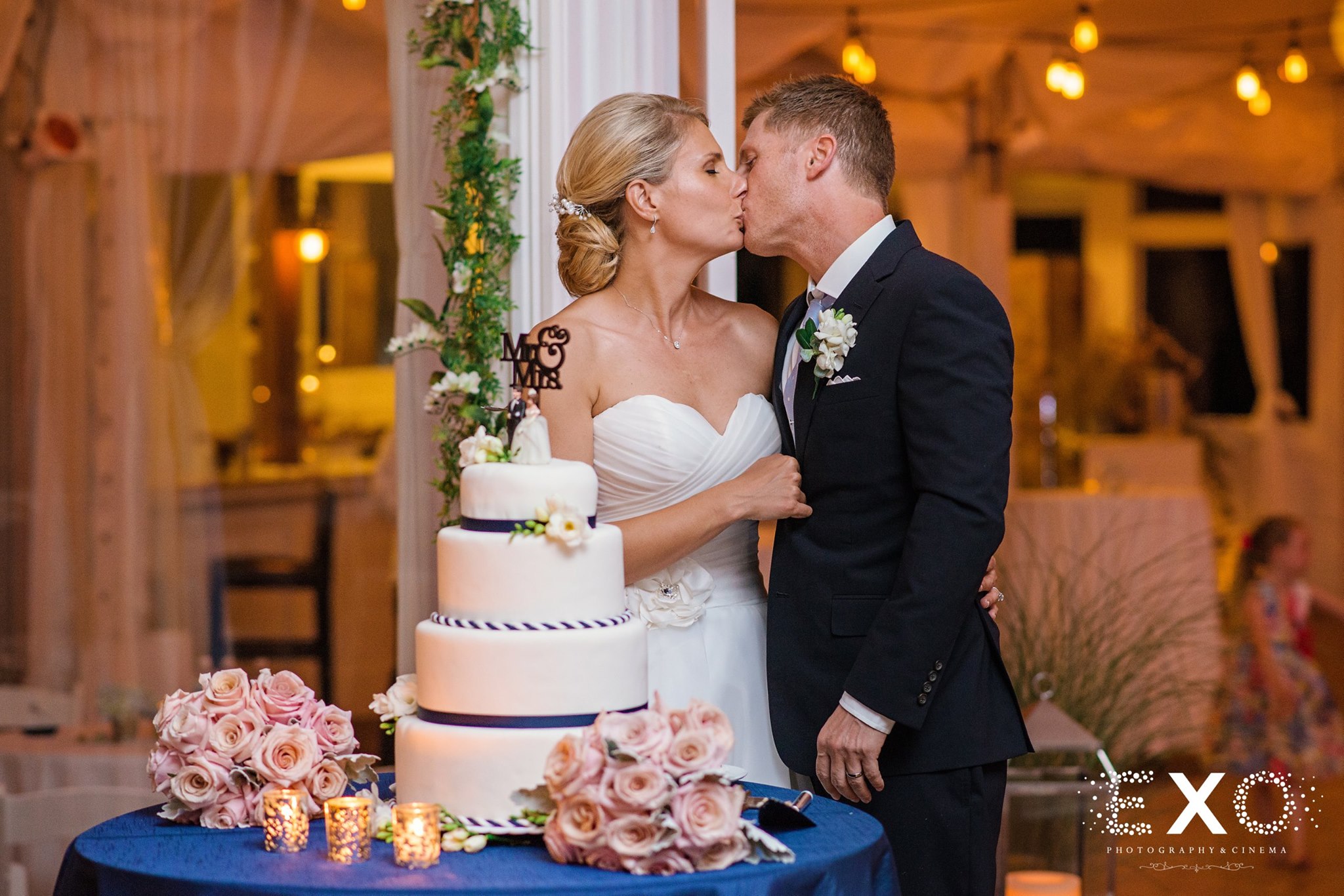 bride and groom kissing at reception at Oceanbleu