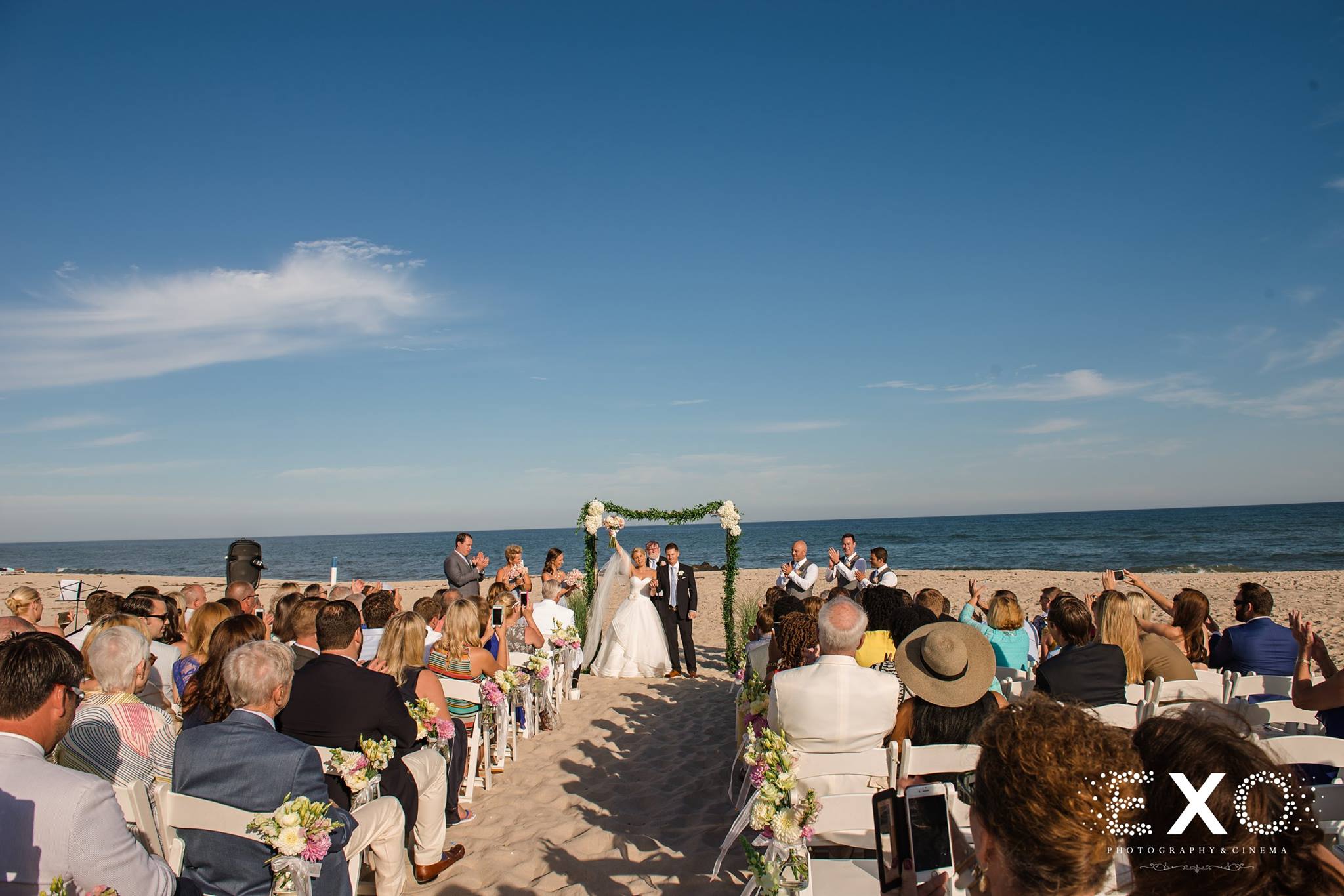 wide shot of bride and groom during ceremony at Oceanbleu