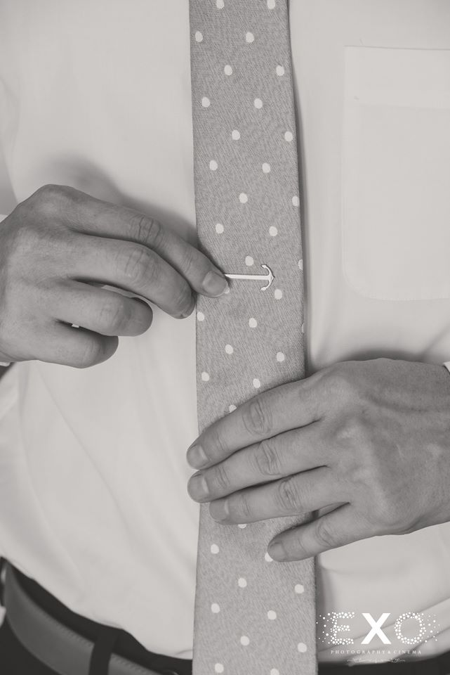 grooms tie with detail in black and white shot