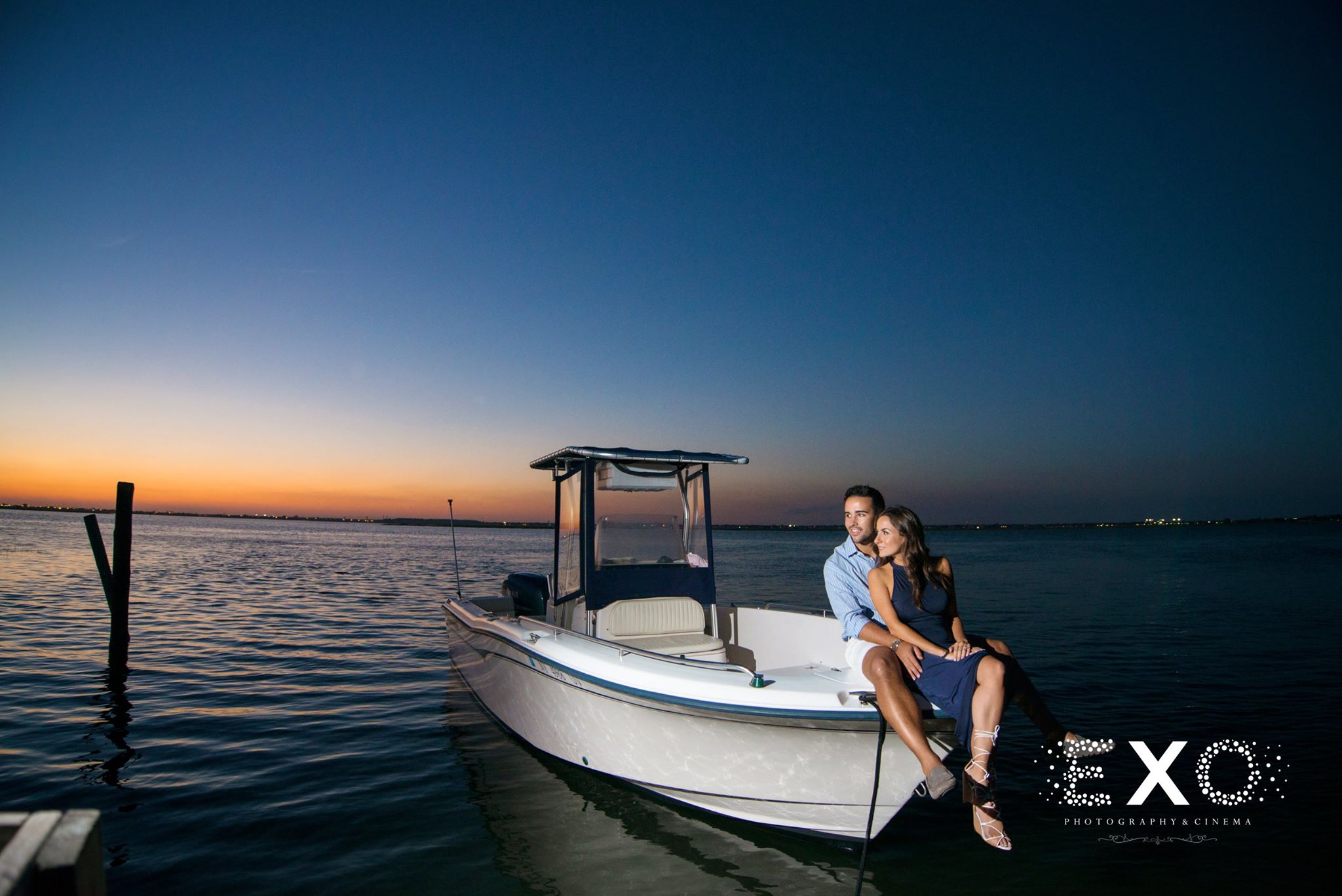 couple sitting on boat in bay