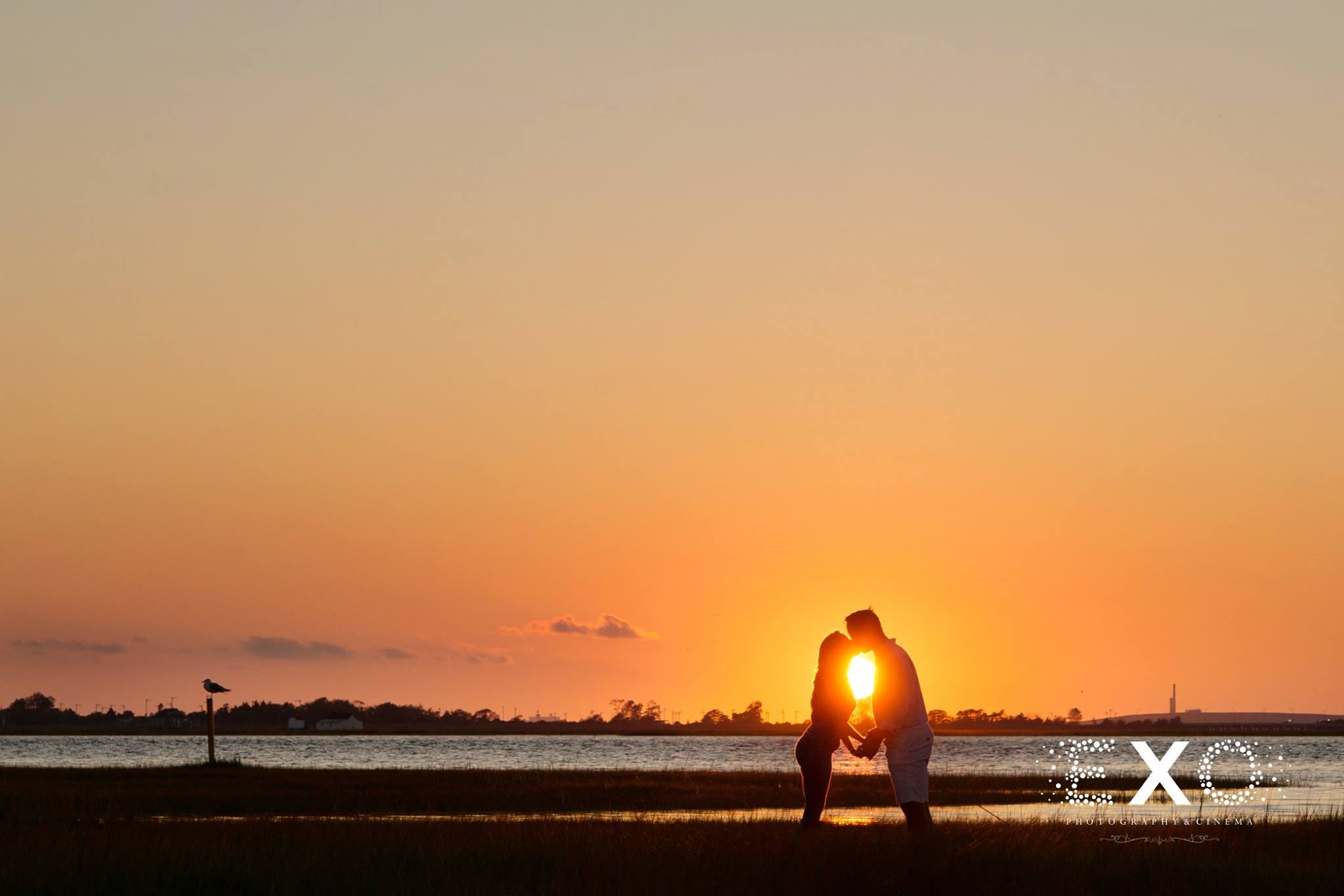 photo of couple kissing in sunset