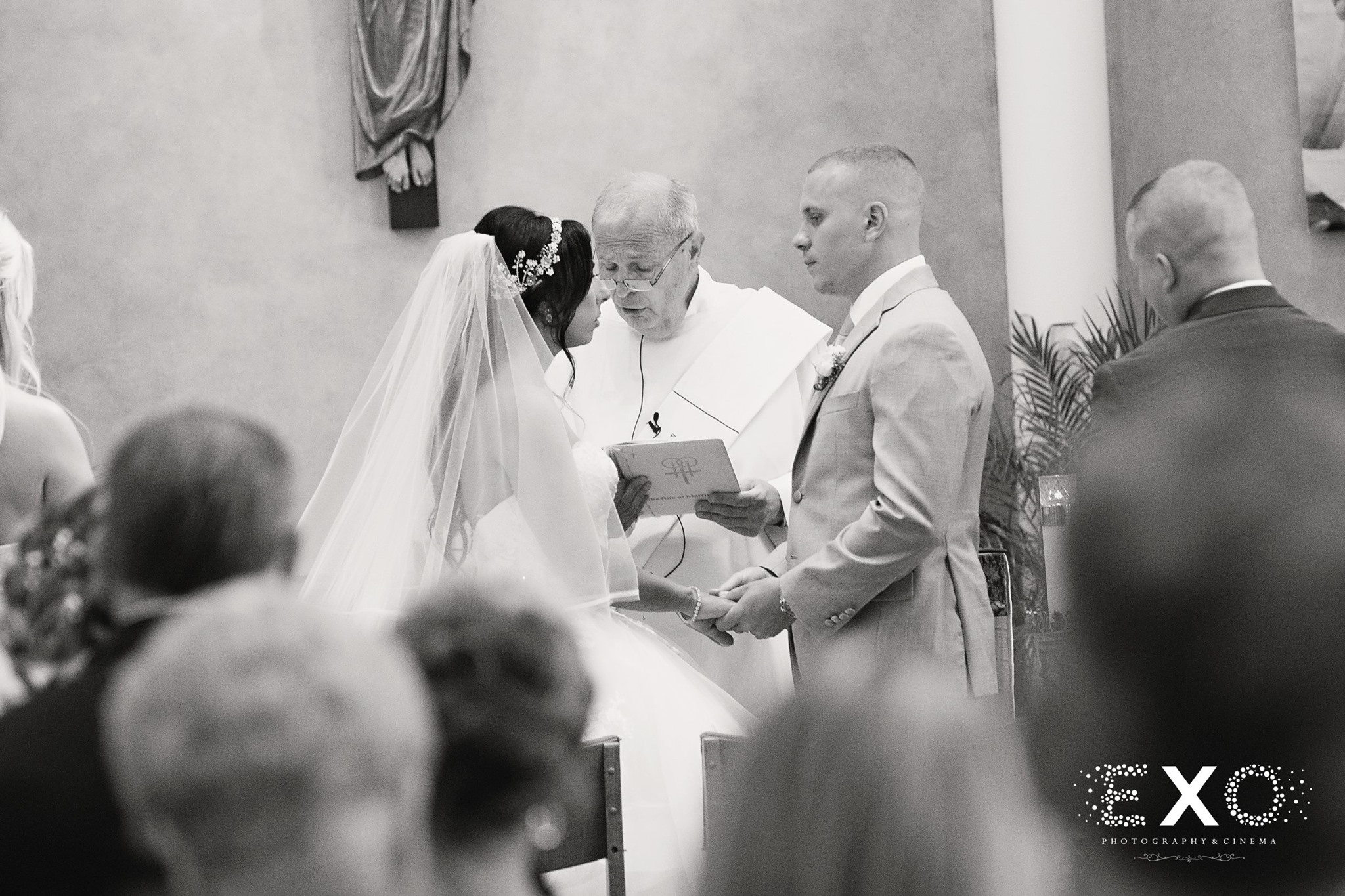black and white photo of dana and steven standing at altar during ceremony