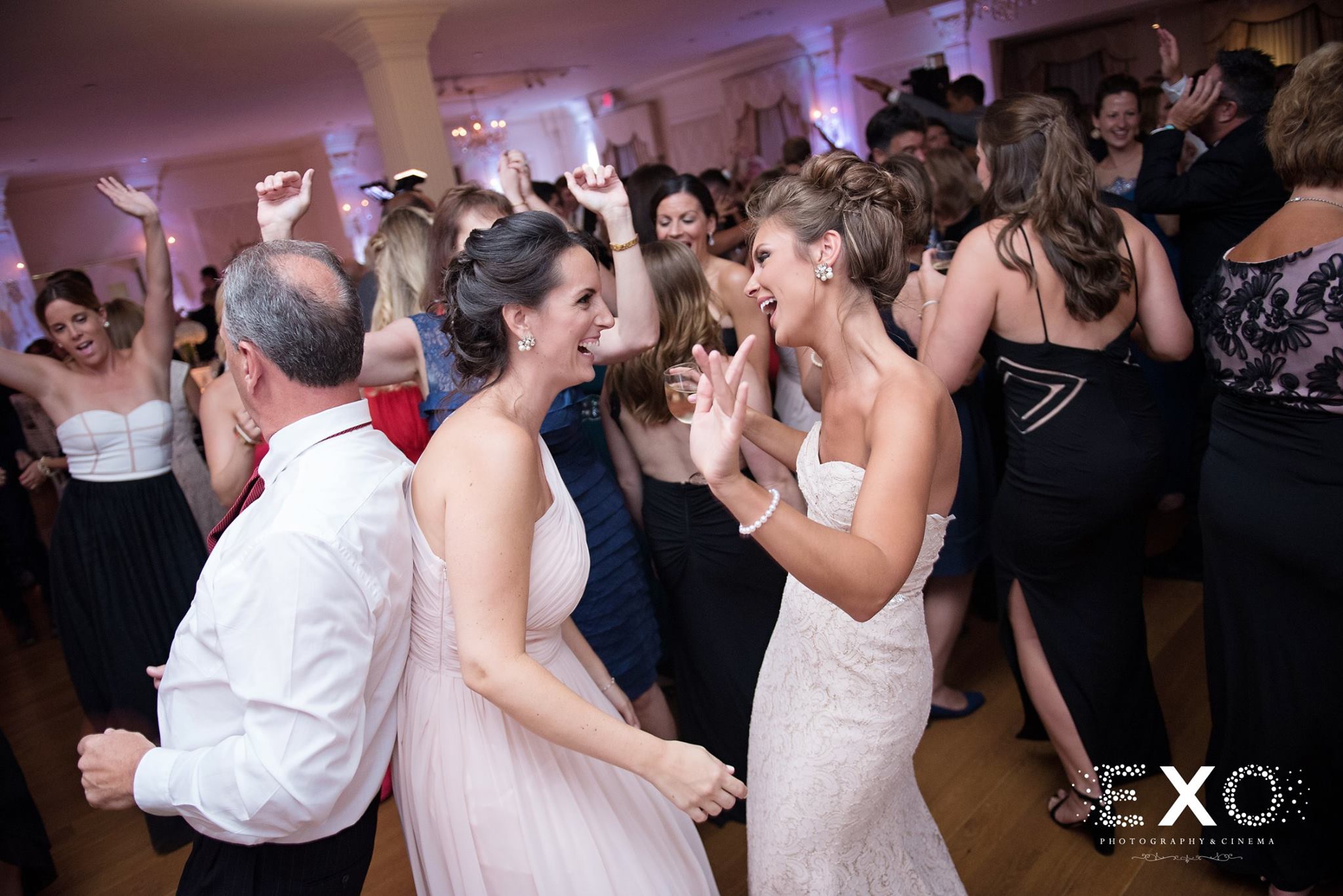 bride dancing with bridesmaid to music by hank lane