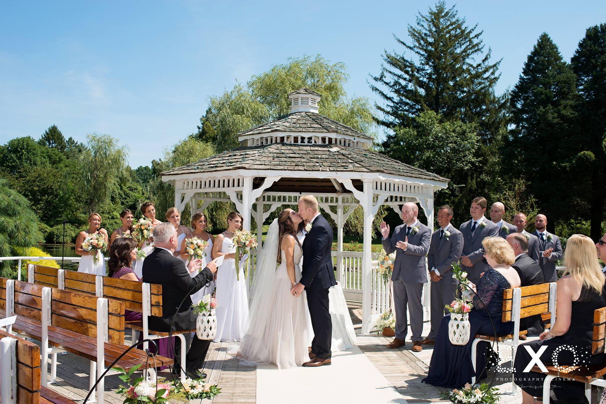 bride and groom kissing at the altar at Flowerfields Celebrations