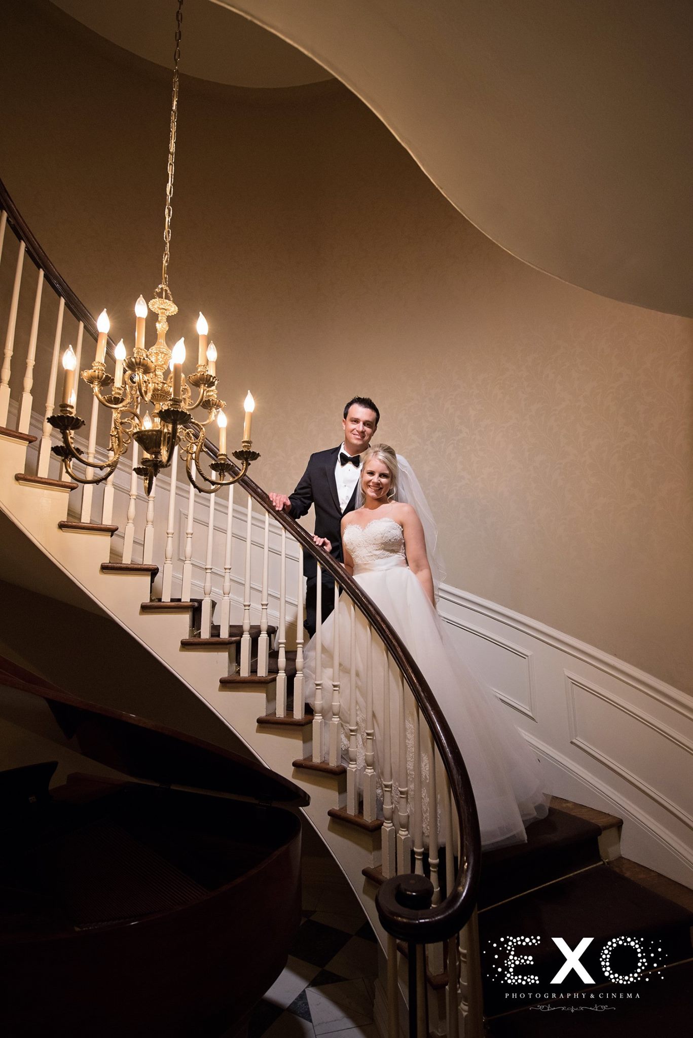 bride and groom on staircase at royalton mansion