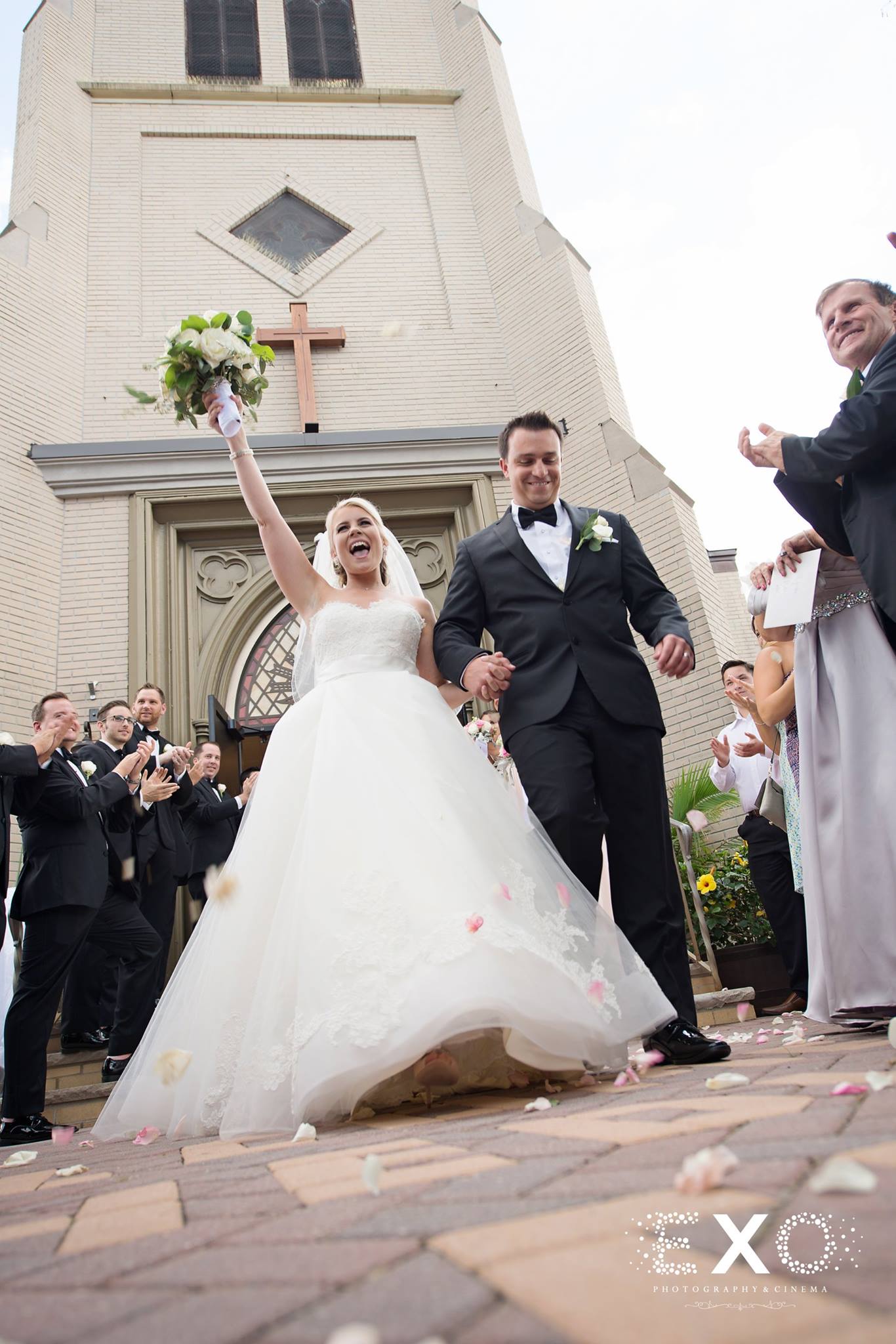 bride and groom laughing after ceremony outside st hedwigs church in floral park