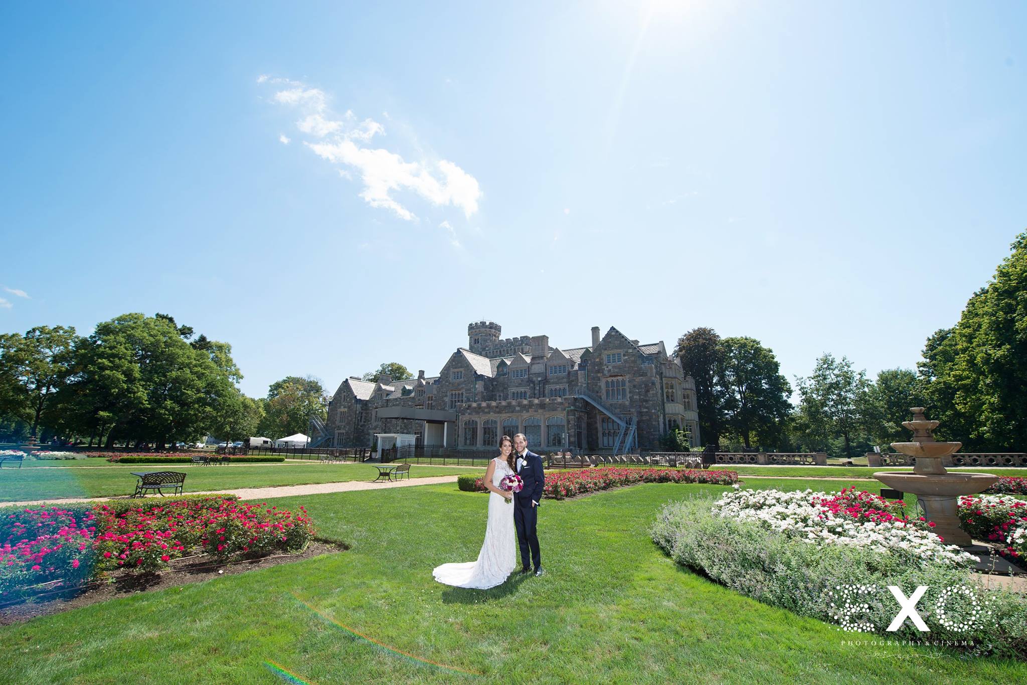 wide shot of bride and groom at Hempstead House gardens