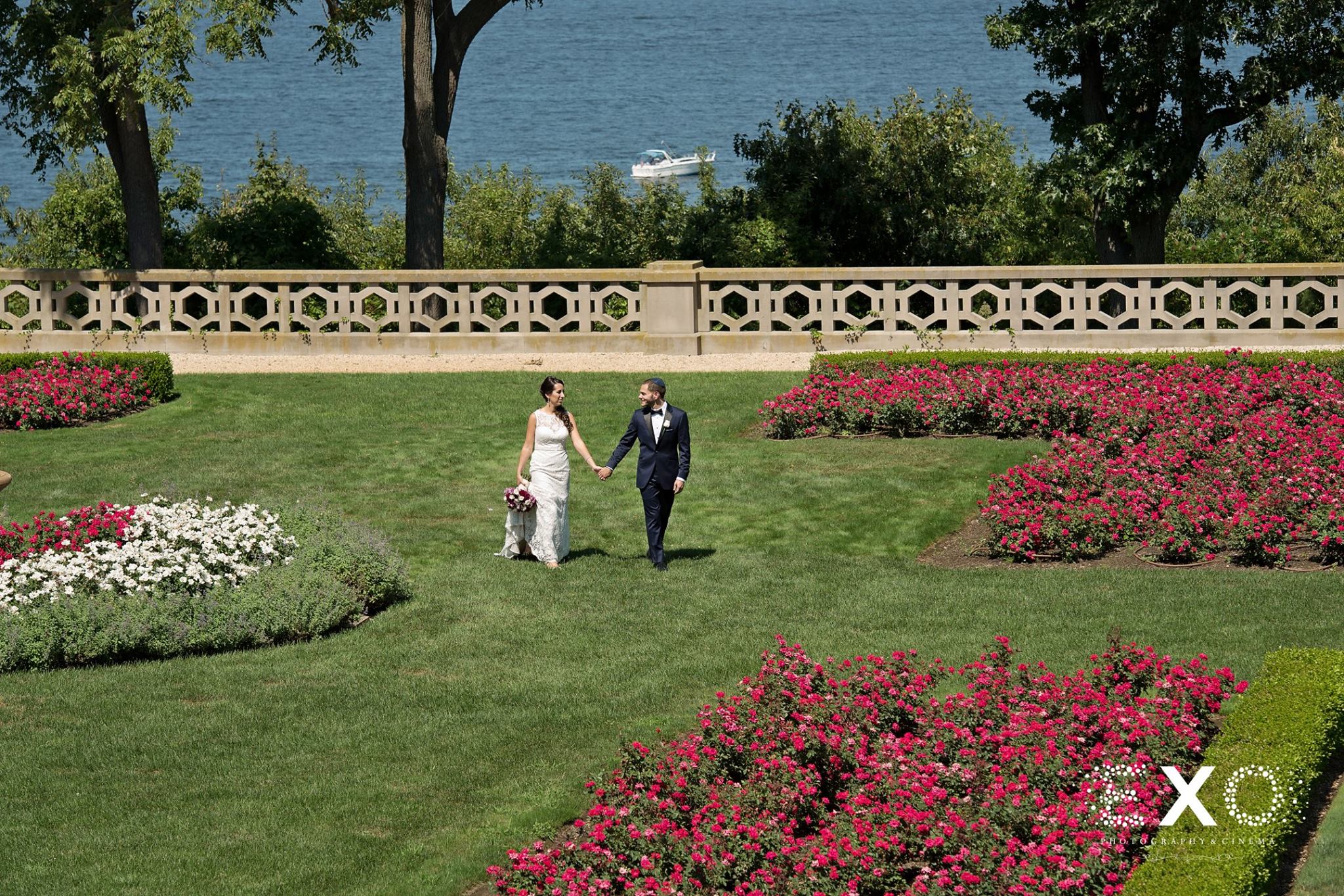 bride and groom walking in lawn of Hempstead House
