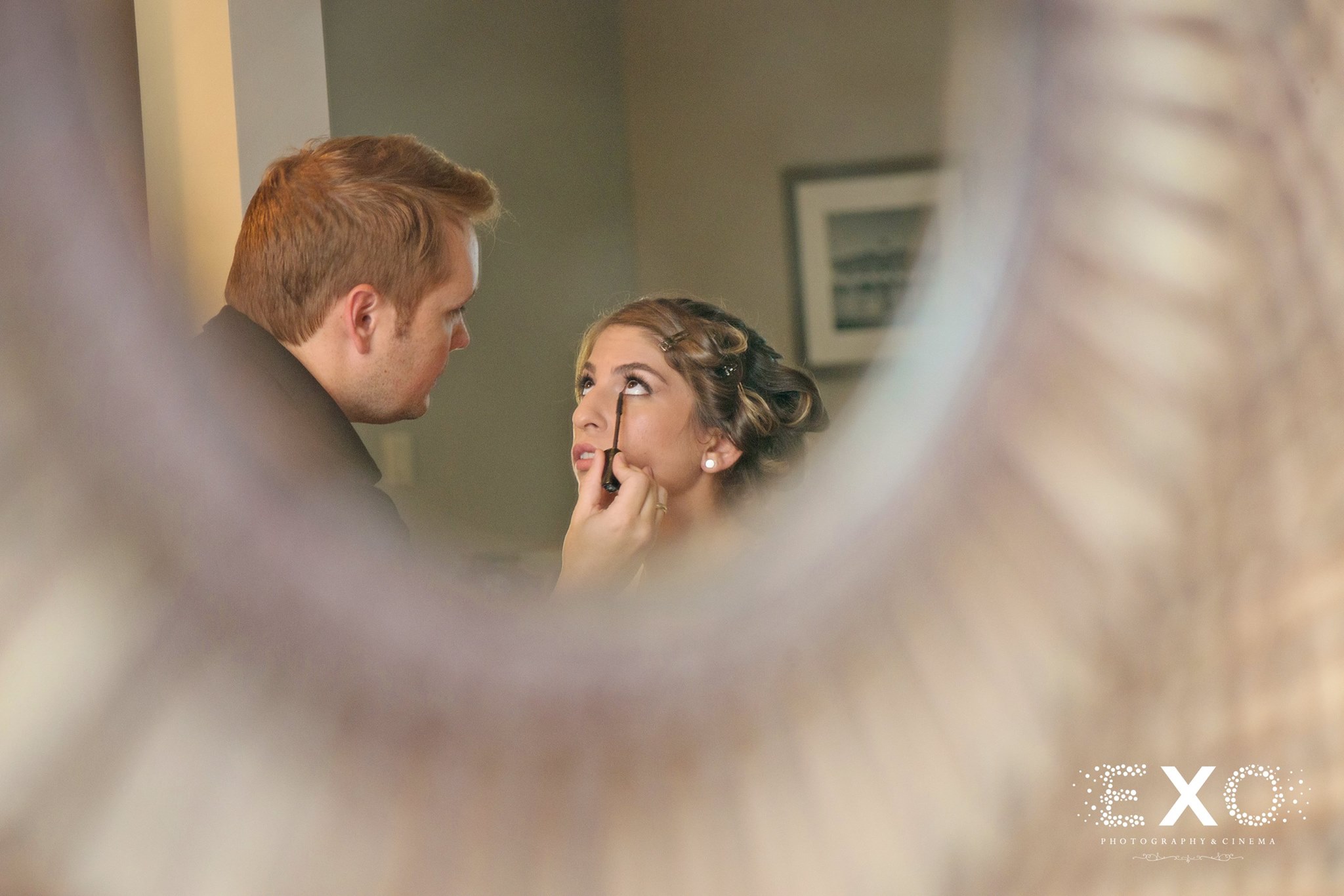 bride having makeup done in mirror by tim wallis