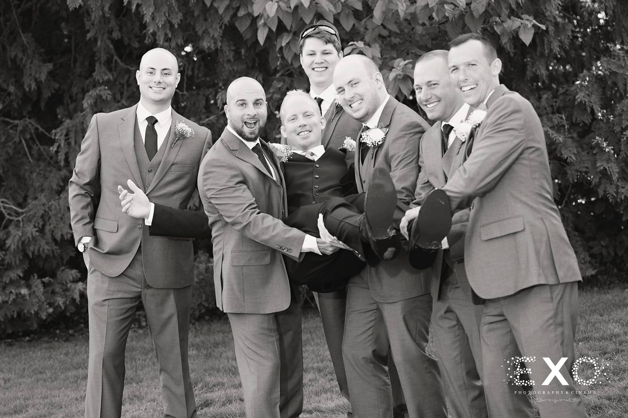 black and white image of groom and groomsmen wearing mens warehouse suits