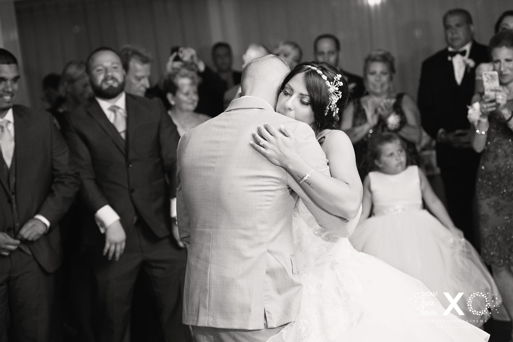 black and white shot of bride and groom dancing