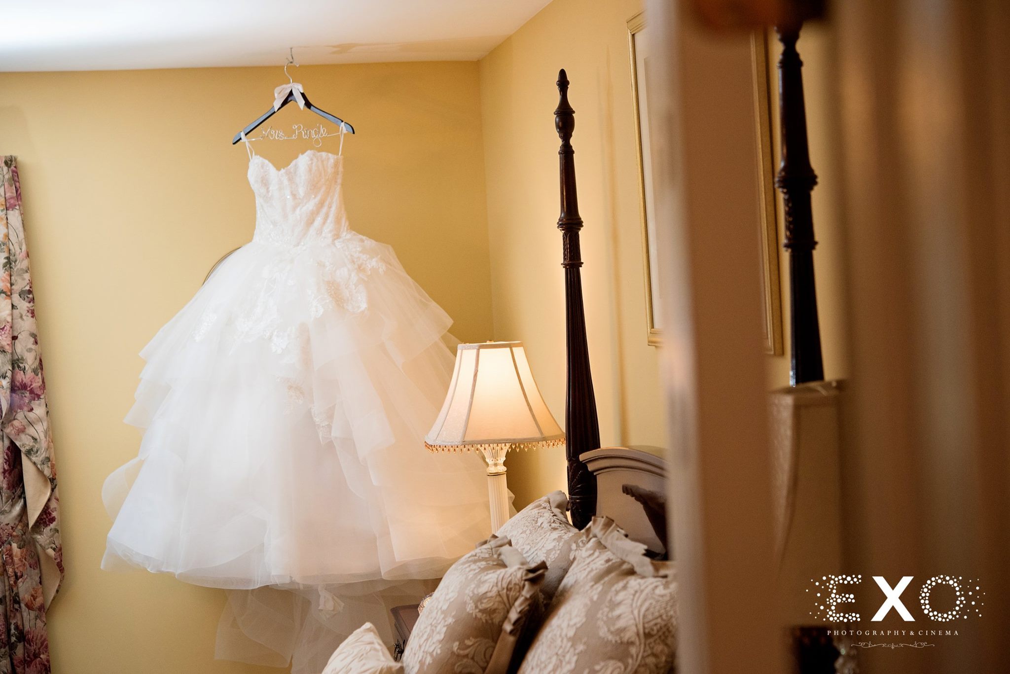 bridal gown from wedding salon of manhasset hanging in corner