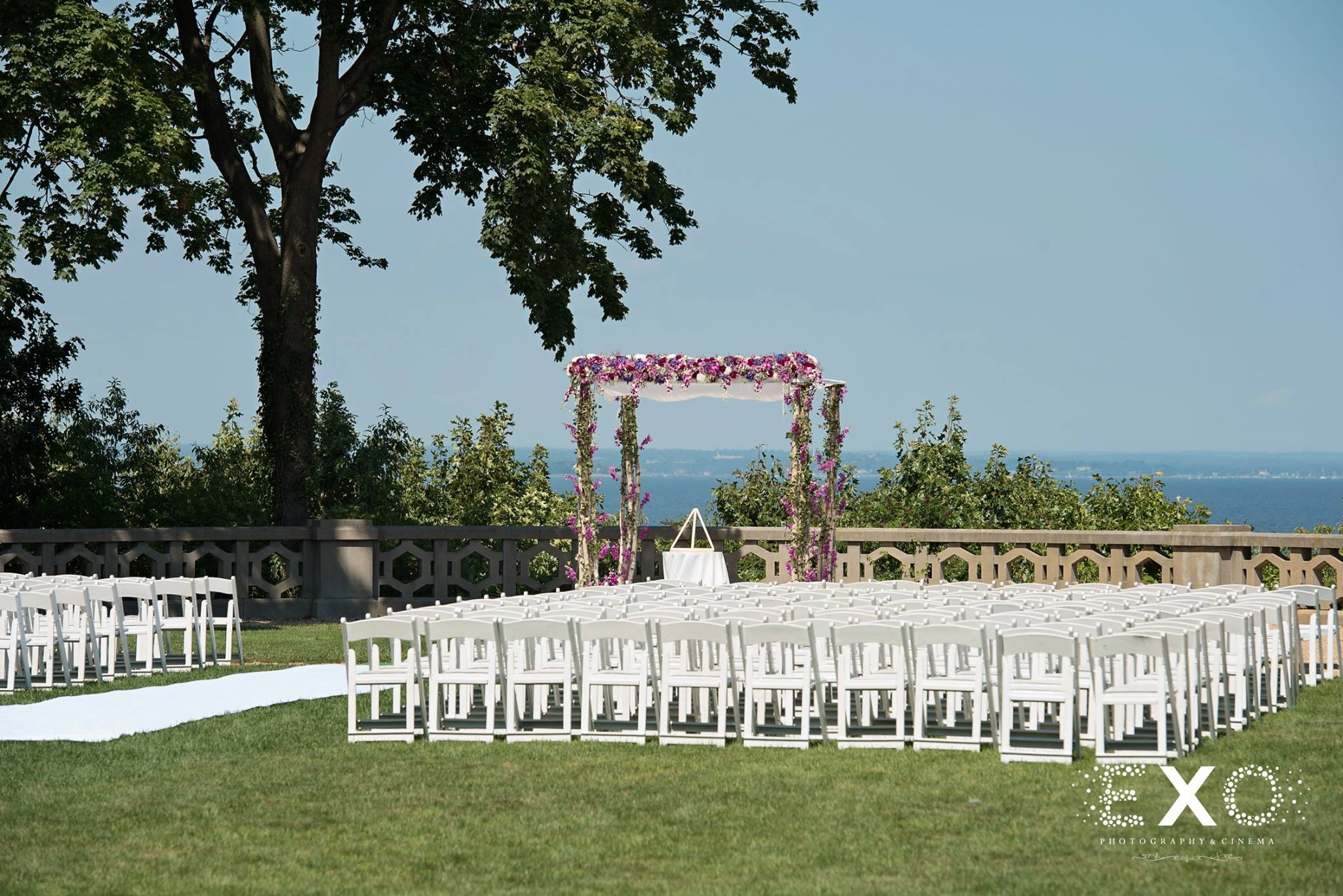 white chairs and altar at wedding ceremony coordinated by solutions by cara
