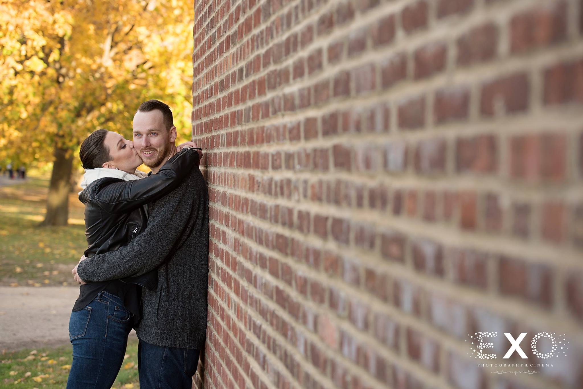 kjell and nicole leaning on brick wall at Caumsett State Park