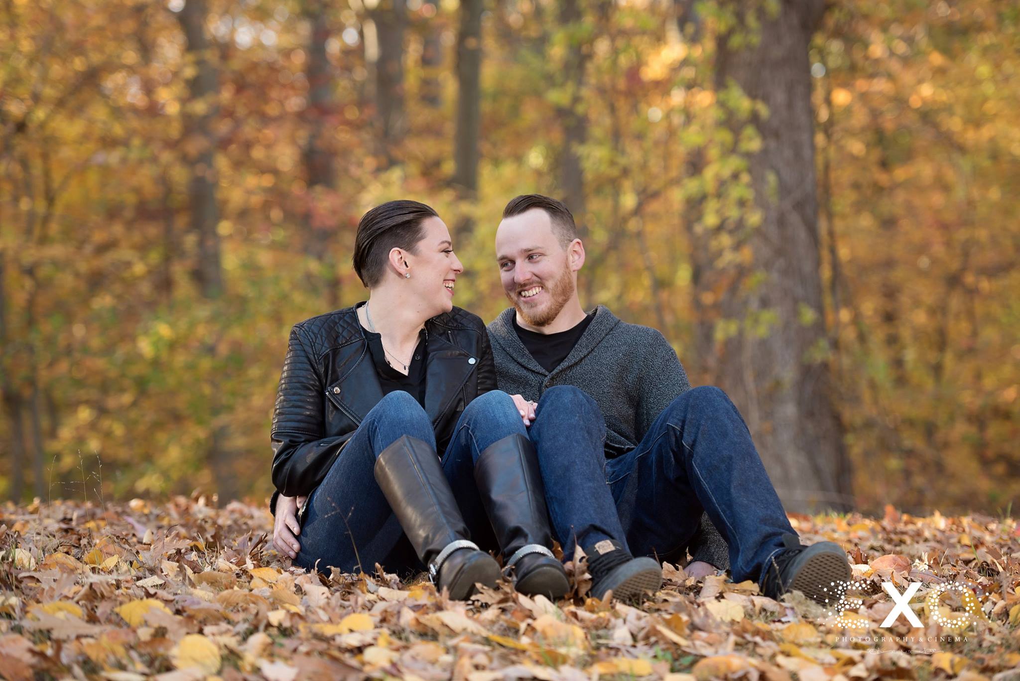 Couple sitting in leaves at state park