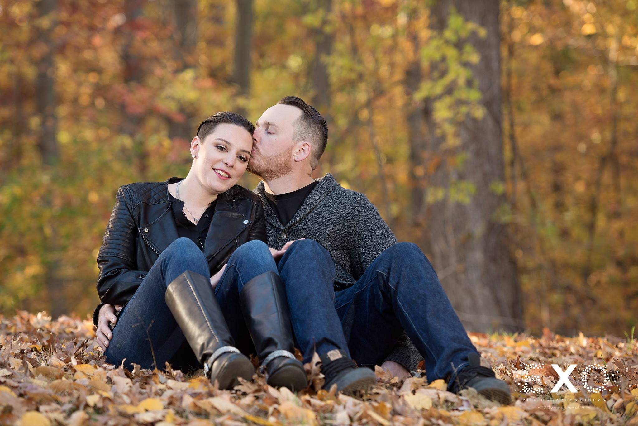 Couple sitting in fall leaves at Caumsett State Park