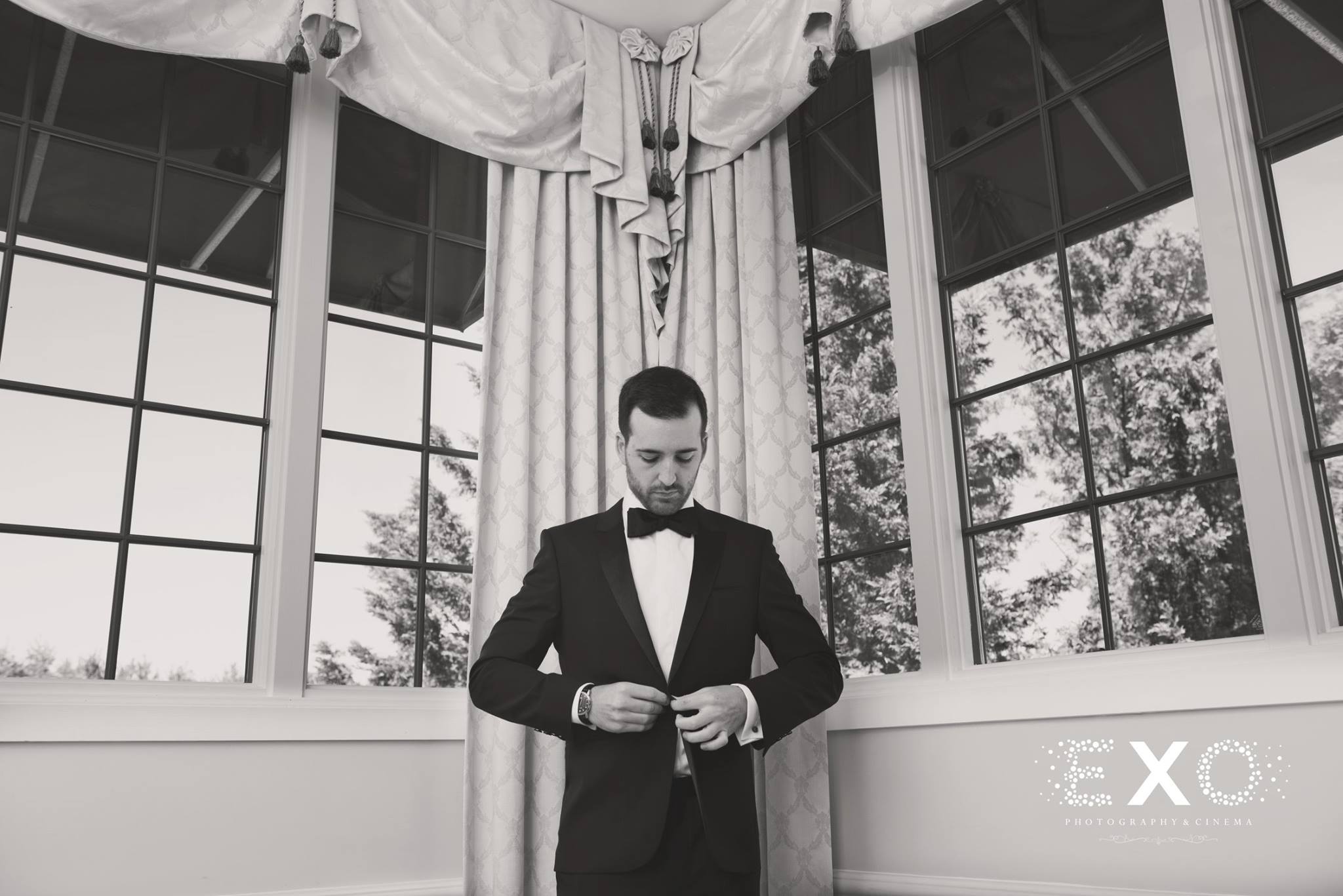 black and white image groom wearing hugo boss suit