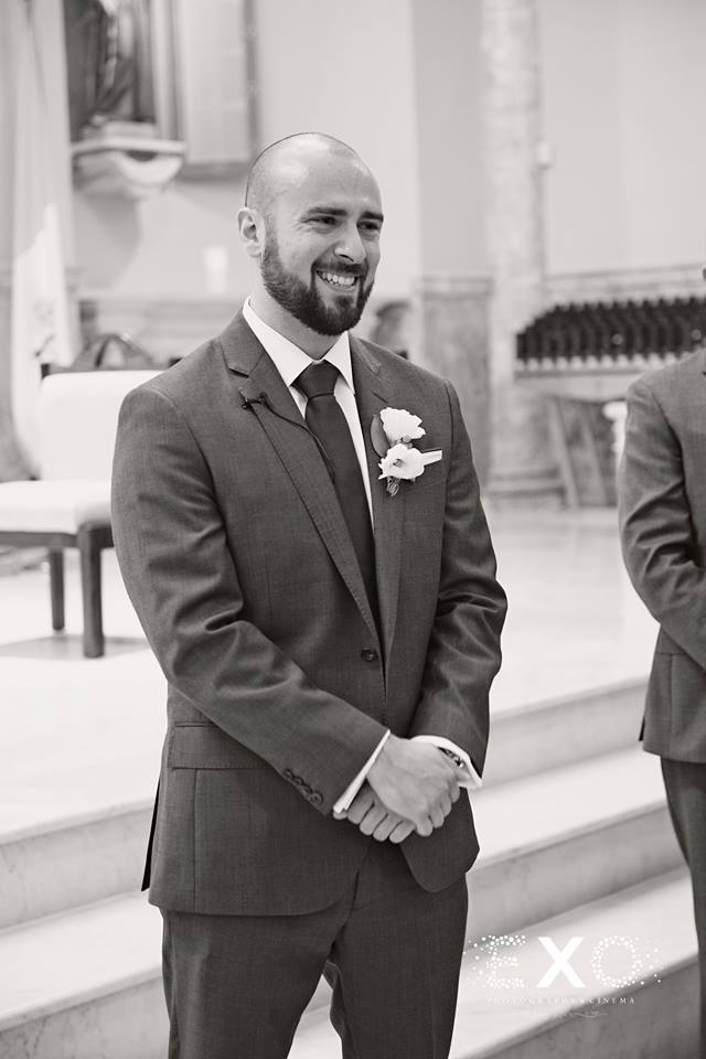 black and white image of groom seeing bride walk down aisle at st annas church
