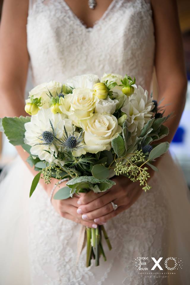 bride with bouquet of flowers by nicole troncone and gown by The Wedding Salon of Manhasset