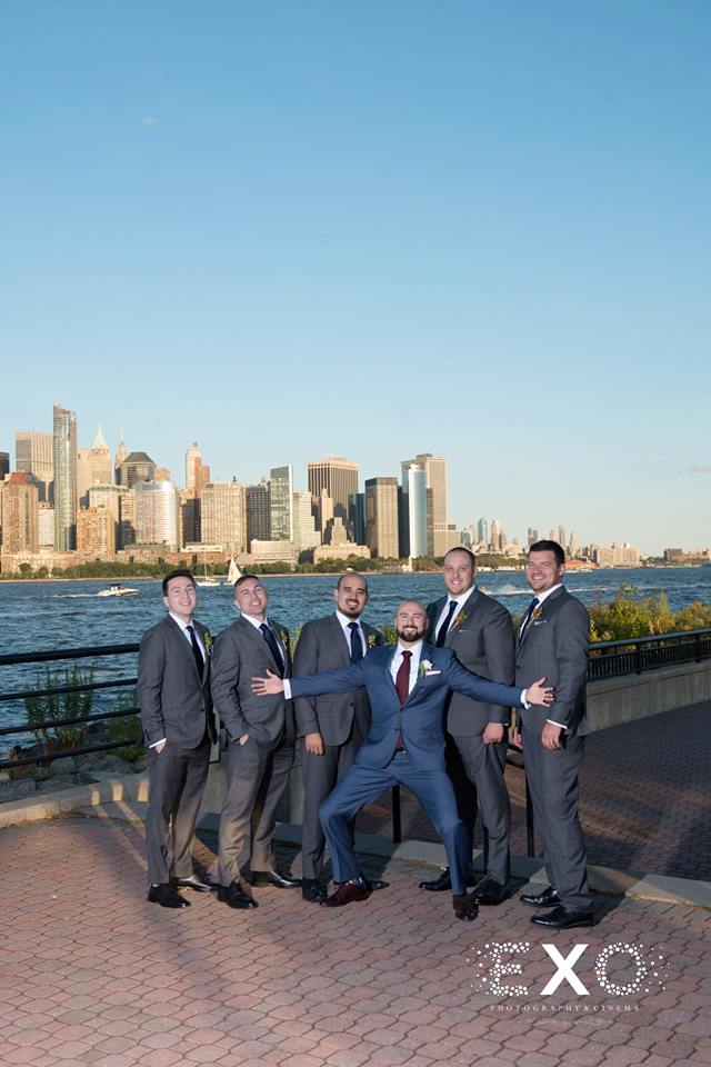 groom and groomsmen wearing j. crew suits by water at maritime parc