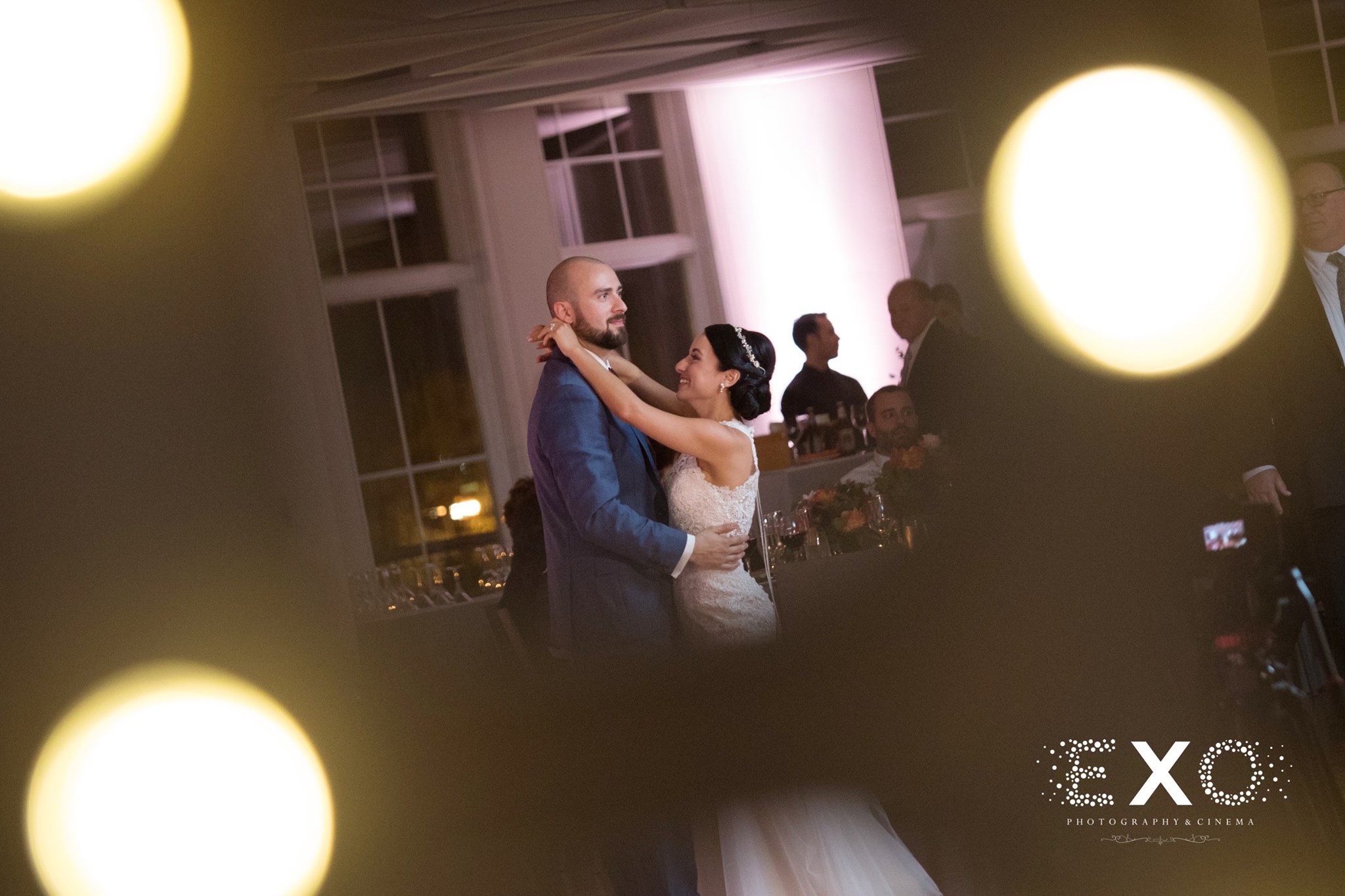 light flare image of bride and groom dancing at reception