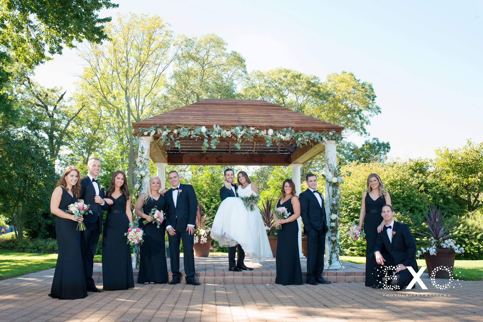 bride groom and wedding party by gazebo 