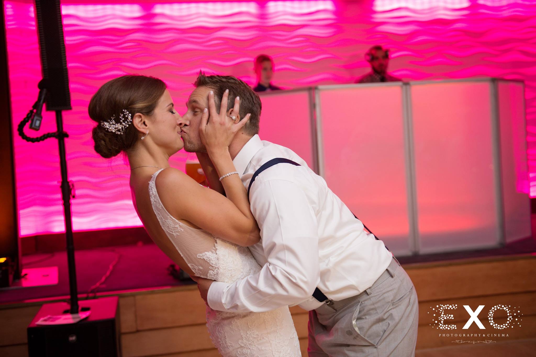 groom kissing bride at reception