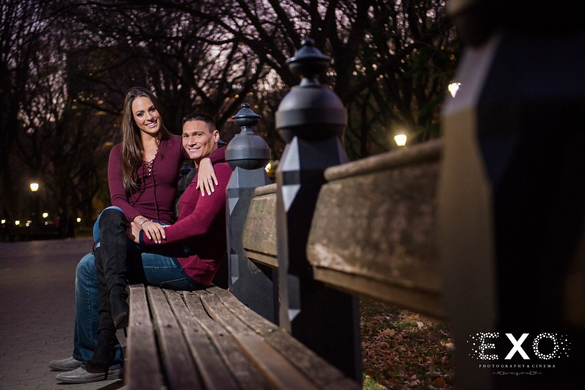 evening shot of couple sitting on bench