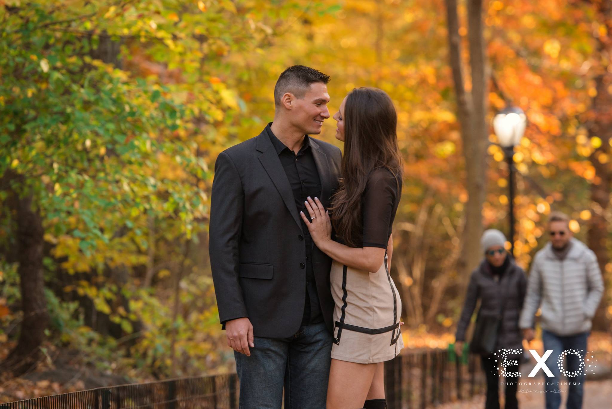 couple standing in central in fall