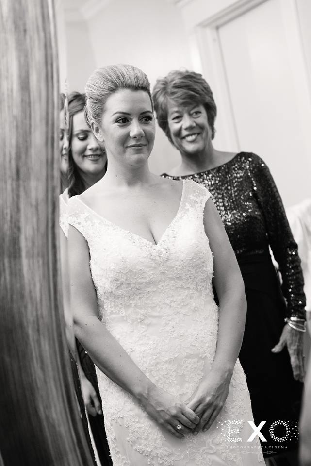 black and white image of bride wearing blossom brides gown with veil from blossom brides