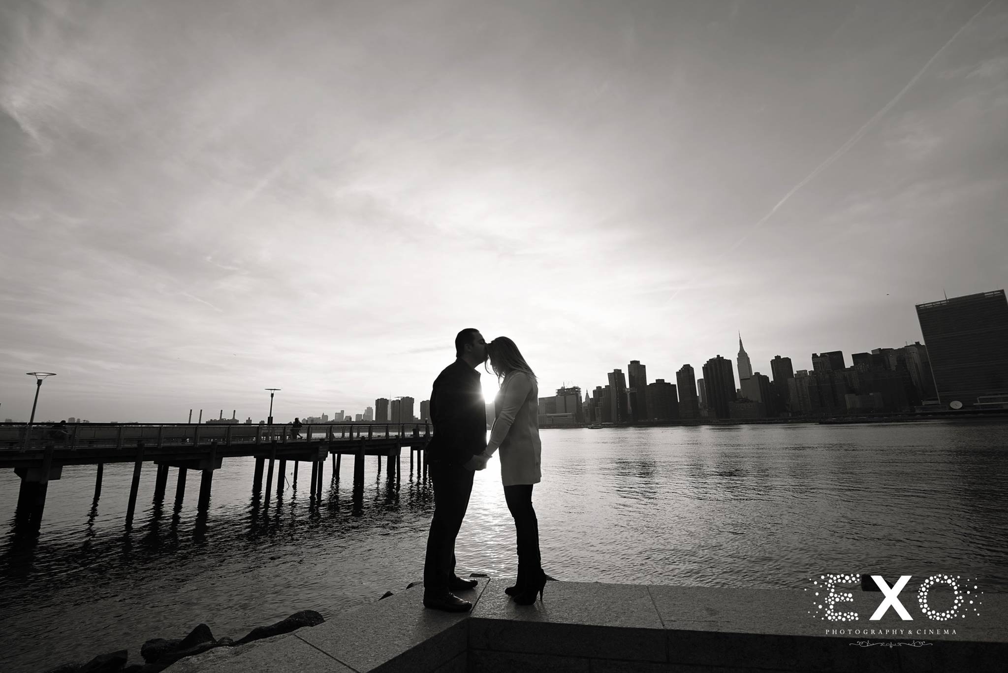 black and white image of couple near water by Gantry Park