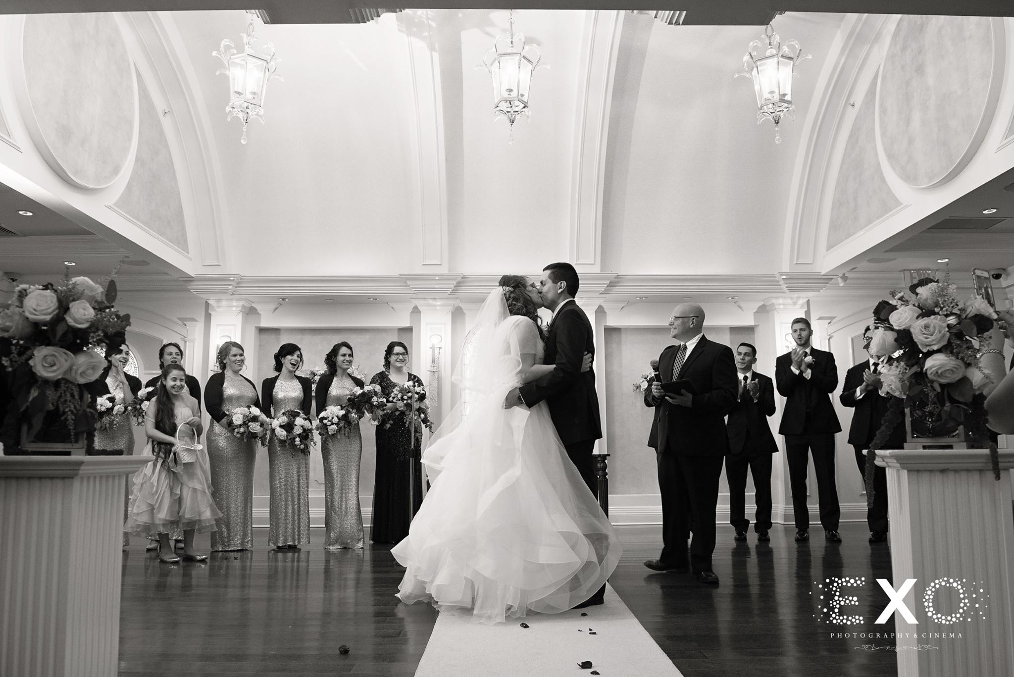 black and white image of couple kissing at wedding
