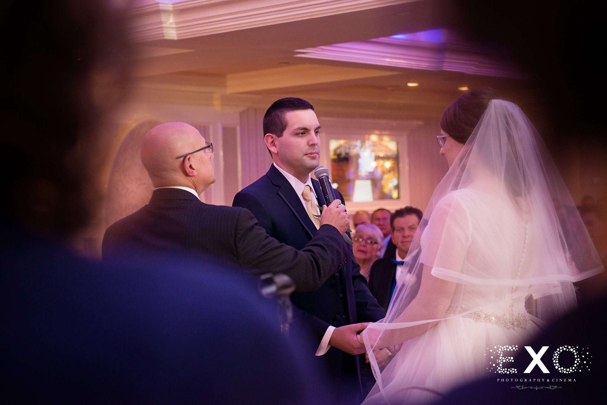 bride and groom sharing vows at Watermill Caterers wedding