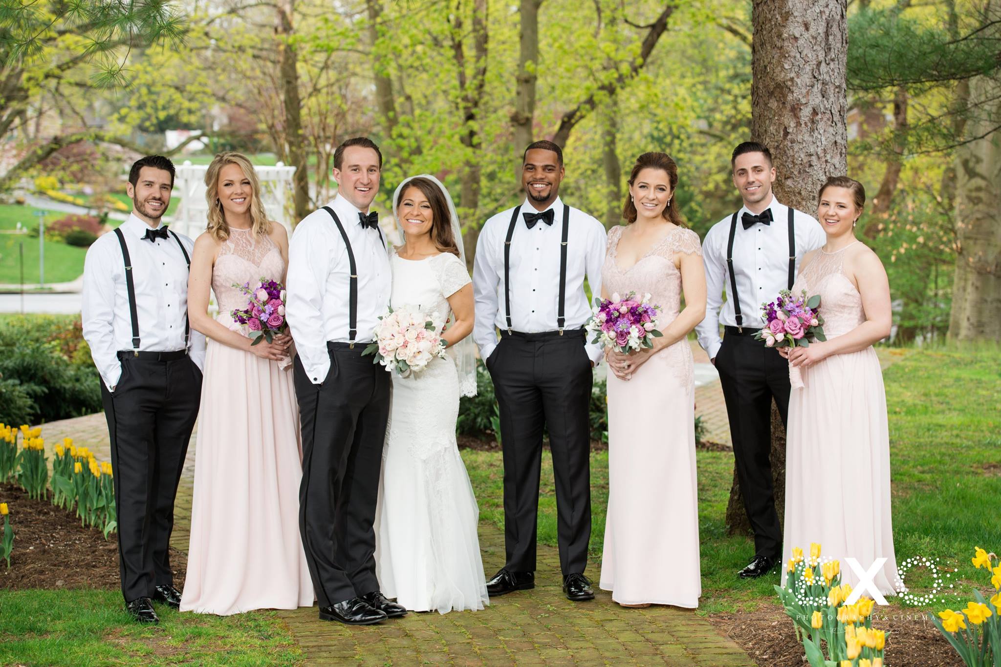 wedding party in green area at royalton mansion wearing Hayley paige dresses