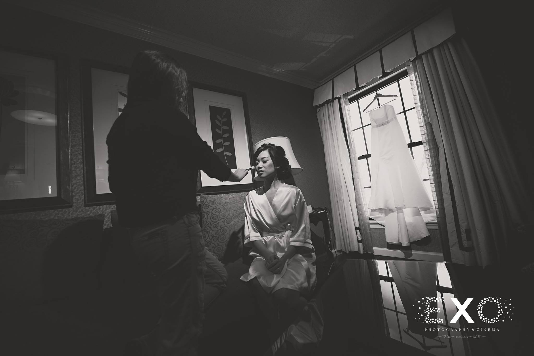 black and white image of bride getting ready with Erica does makeup