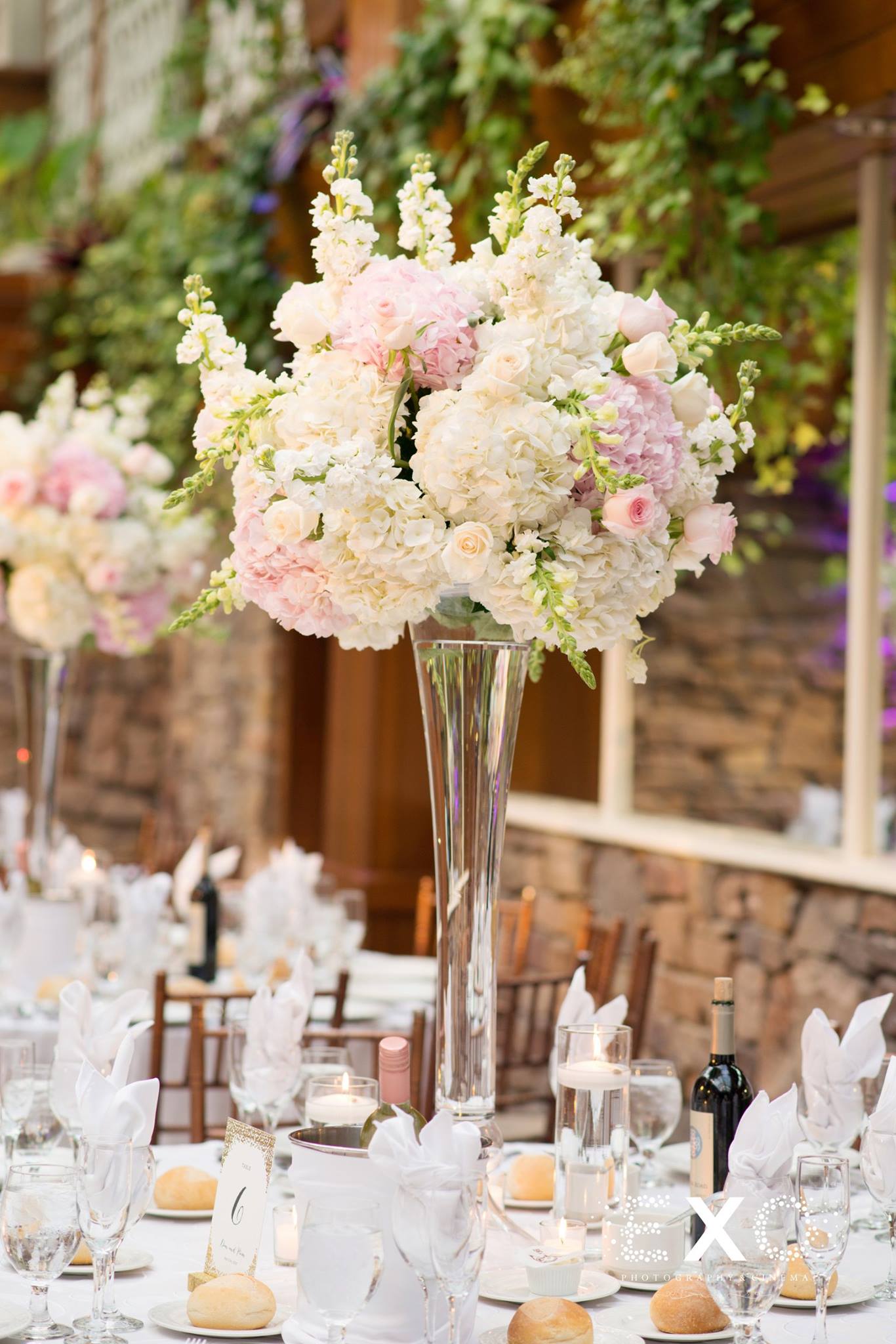 wedding table settings with floral by pedestals