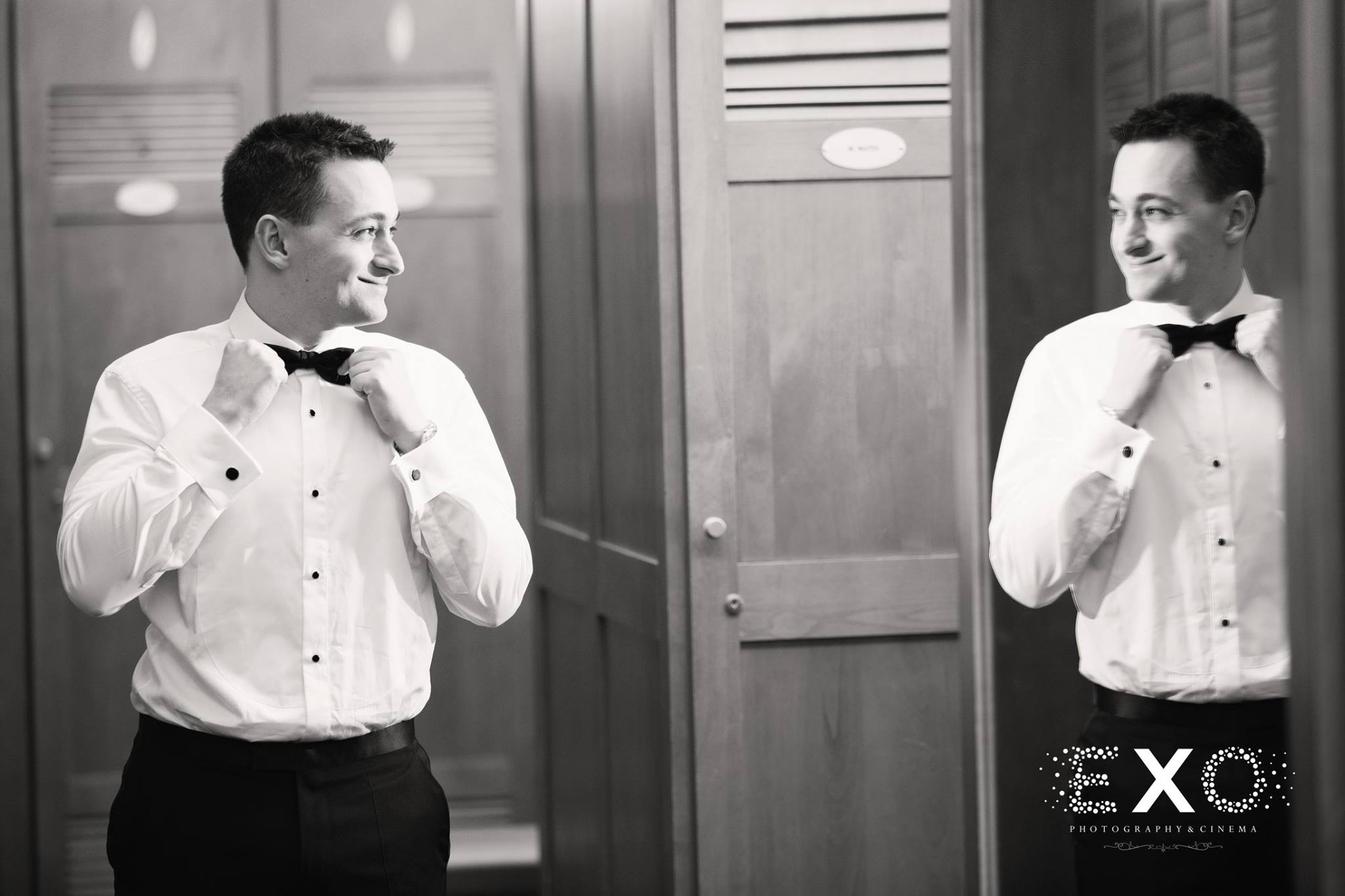 black and white image of groom getting ready in hugo boss suit