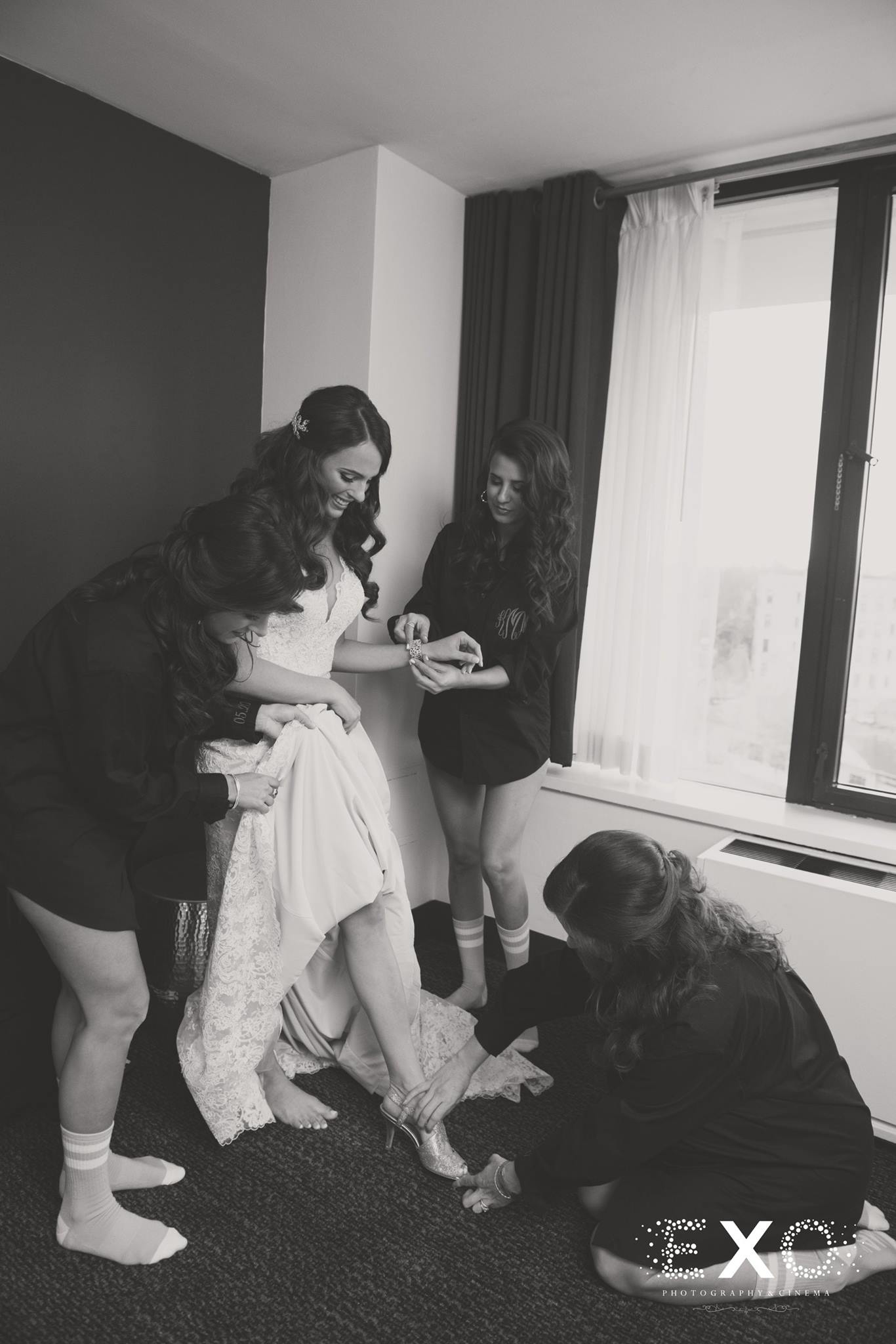 bride putting on jimmy choo shoes