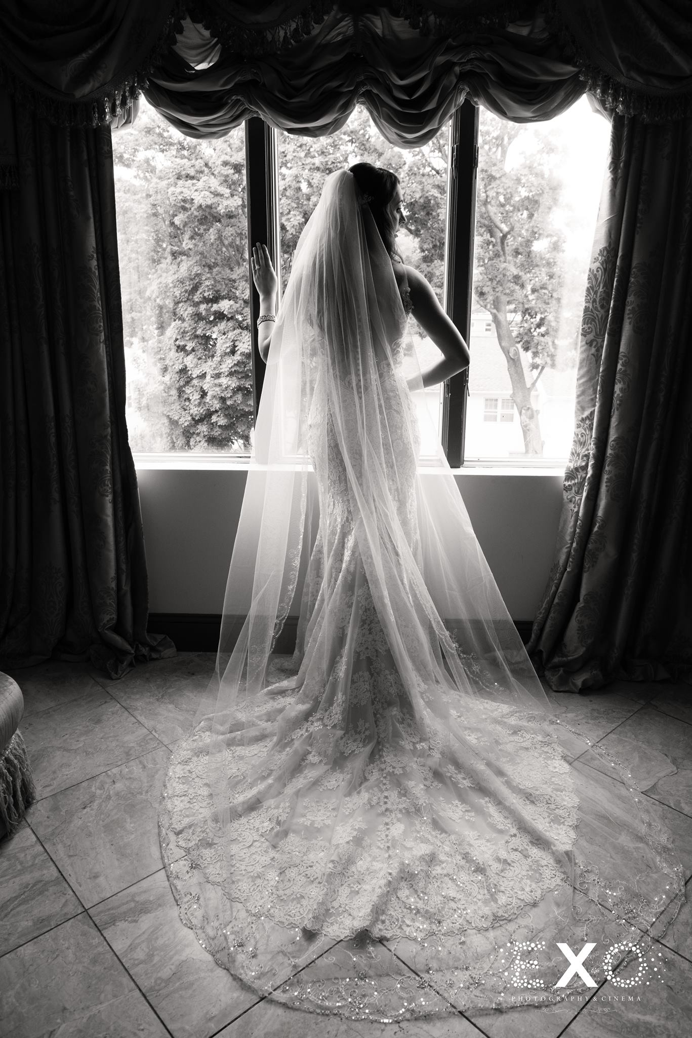 black and white image of bride in gown by castle couture designed by allure at The Surf Club on the Sound