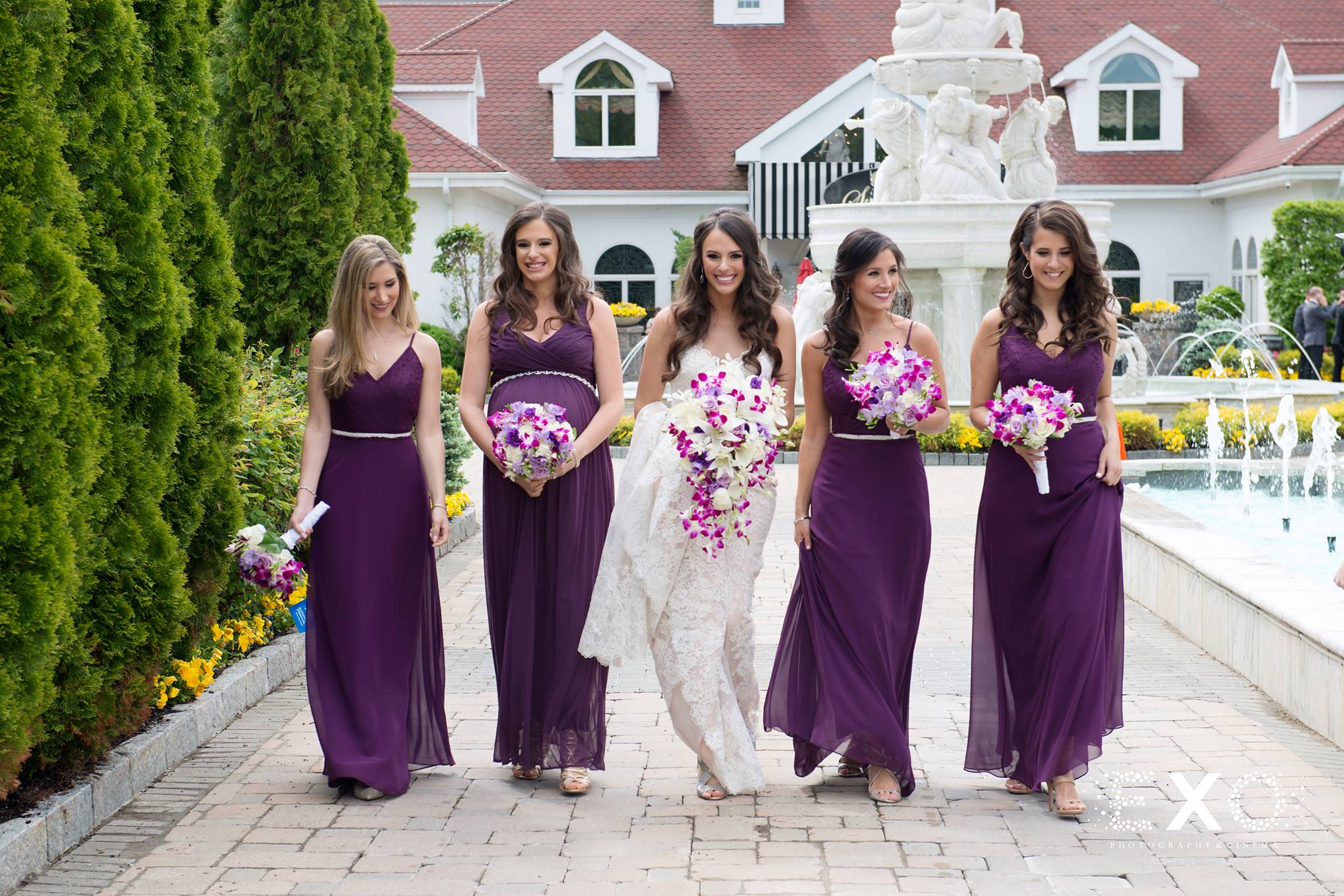 bride and bridesmaids wearing gowns by castle couture and here comes the bridesmaids with arcadia florist bouquets