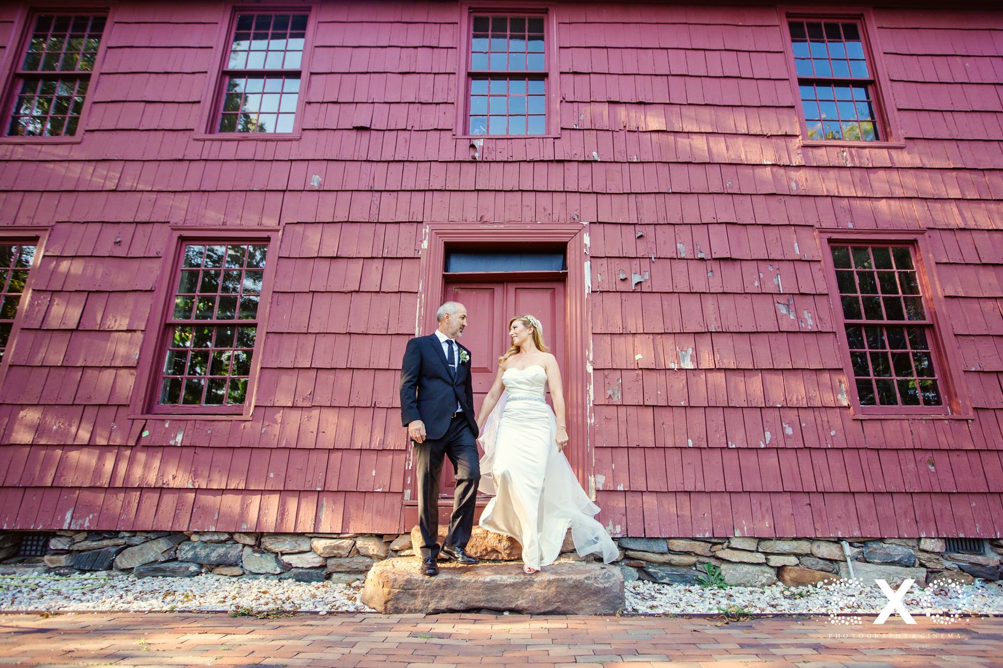 bride and groom holding hands outside George Weir Barn