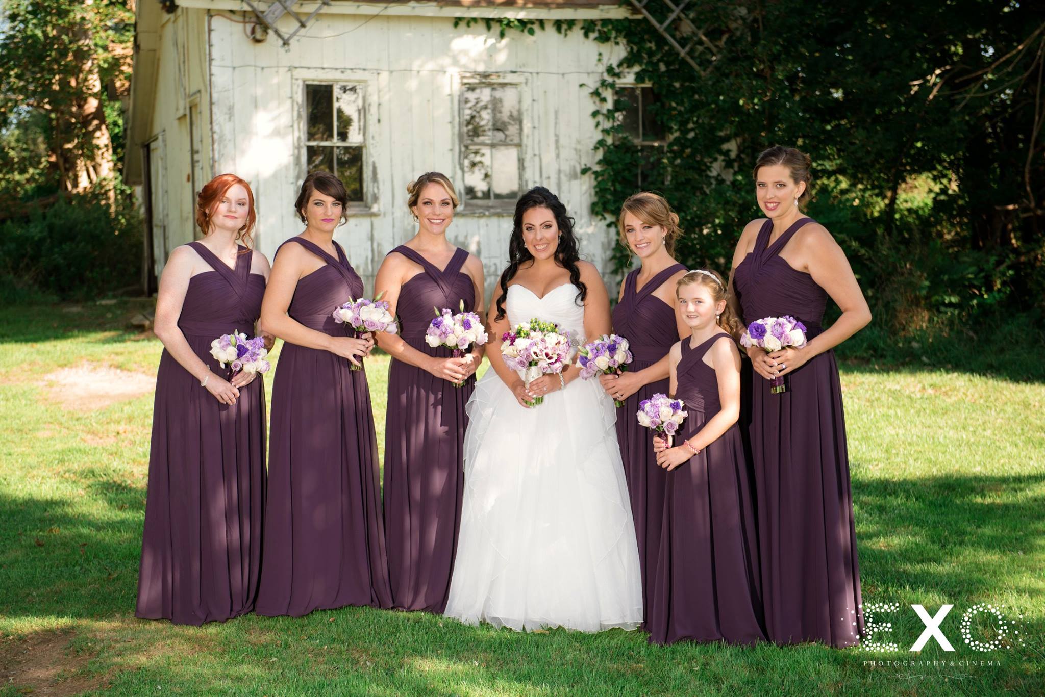 bride and bridesmaids together on grass