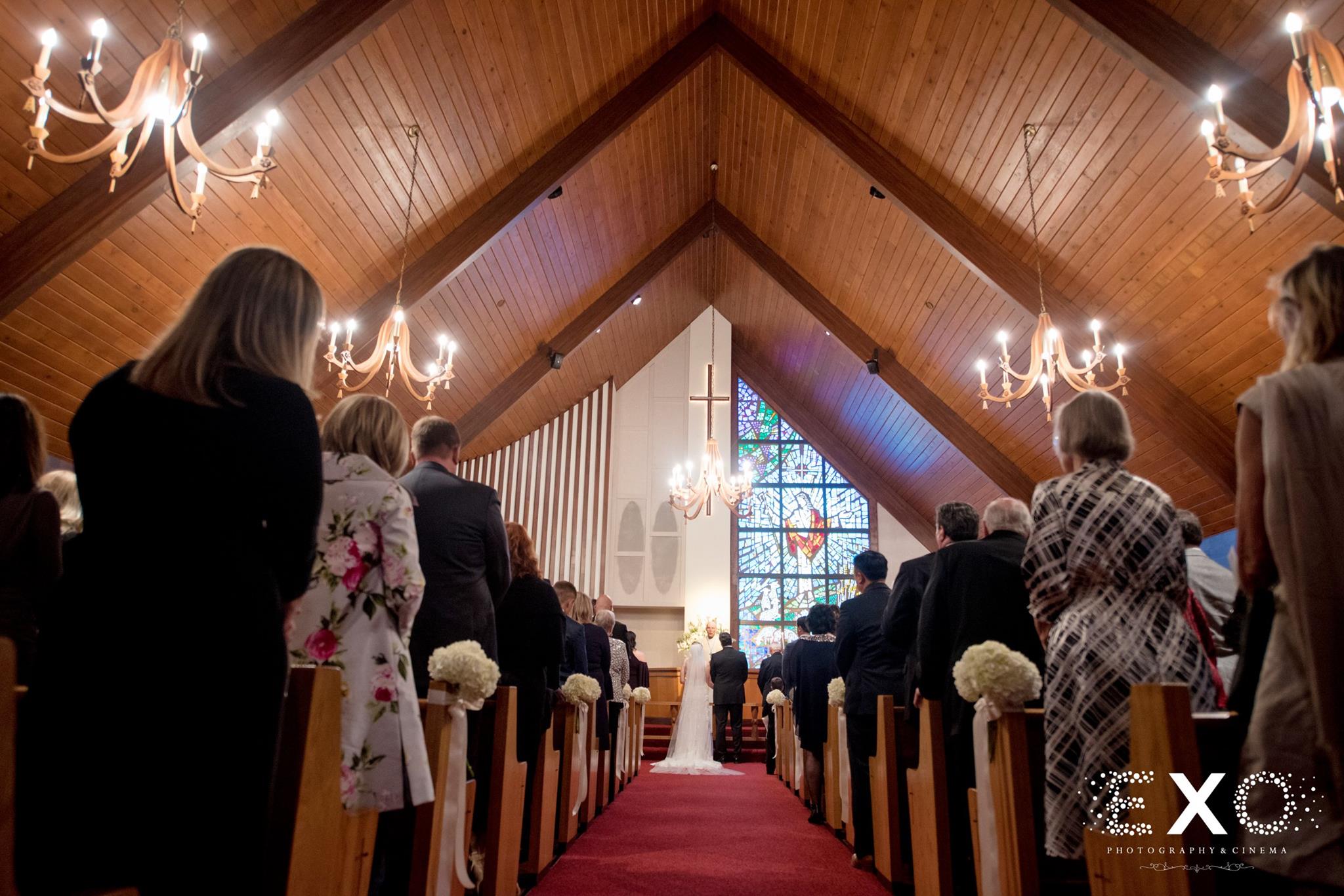 low perspective shot of bride and groom at altar during ceremony